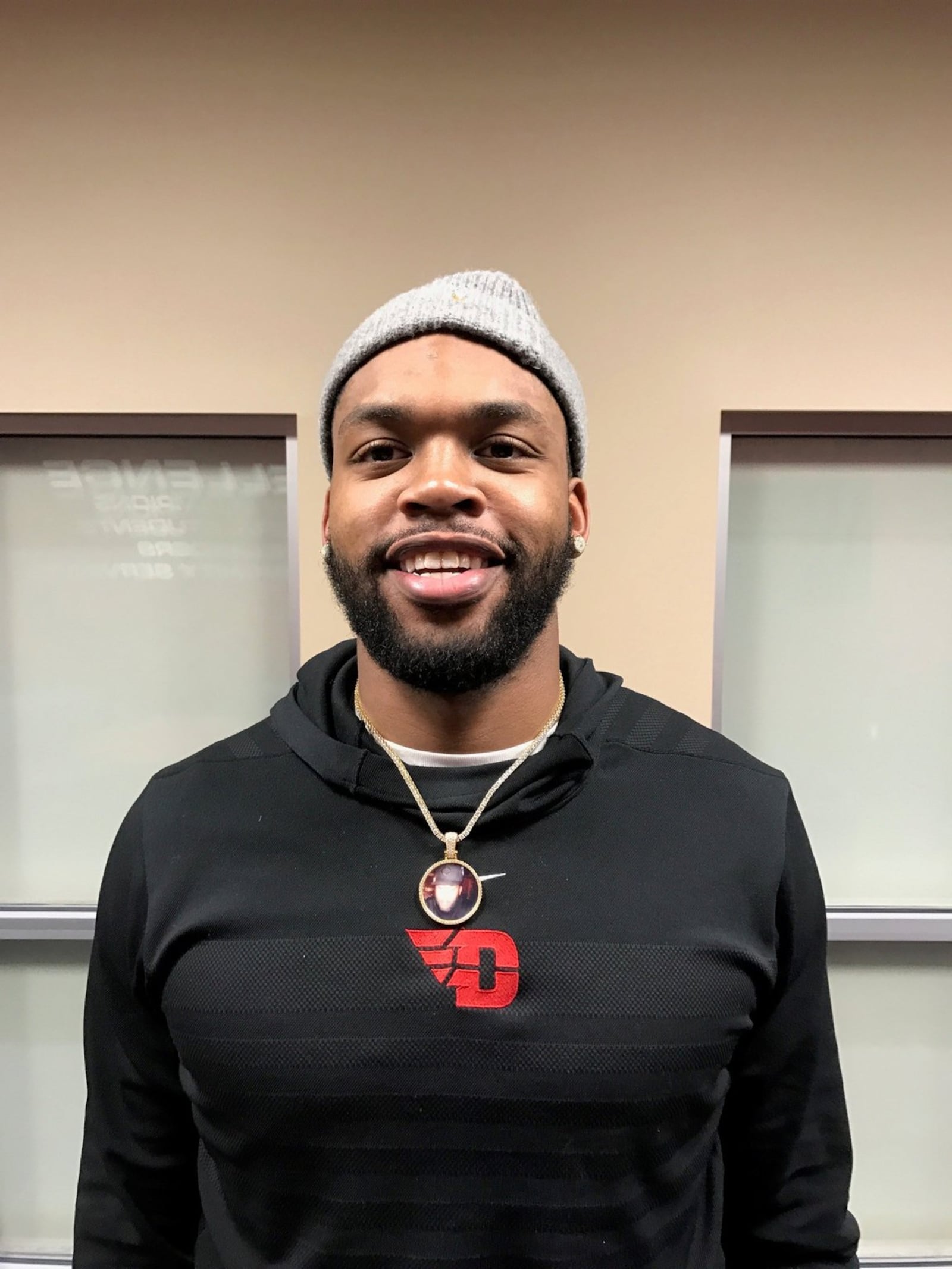 Dayton’s Trey Landers with medallion he wears around his neck. It holds a photo of his late father. Tom Archdeacon/STAFF