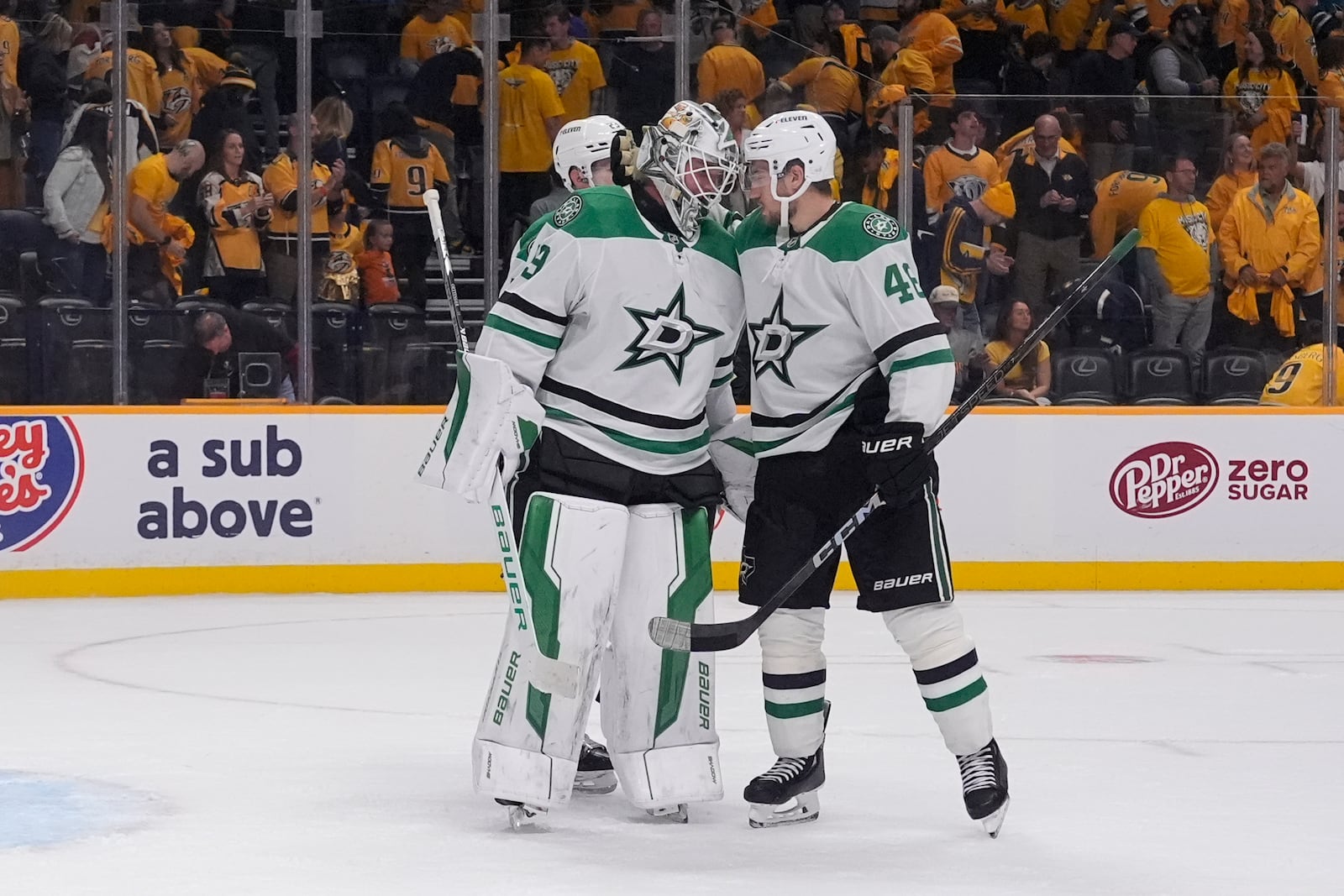 Dallas Stars defenseman Ilya Lyubushkin, right, congratulates goaltender Jake Oettinger, left, after the team's 4-3 win against the Nashville Predators in an NHL hockey game Thursday, Oct. 10, 2024, in Nashville, Tenn. (AP Photo/George Walker IV)