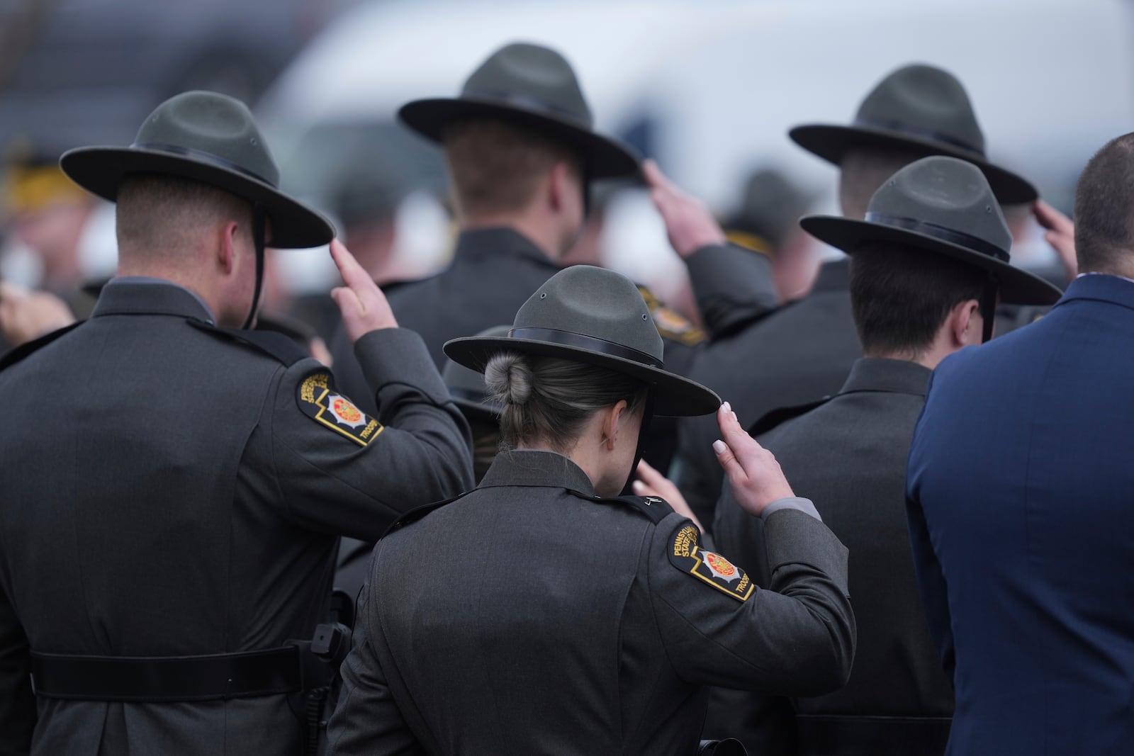 Officers salute the procession as the remains of West York Borough Police Officer Andrew Duarte, arrive for his funeral at Living Word Community Church, in Red Lion, Pa., Friday, Feb. 28, 2025. (AP Photo/Matt Rourke)