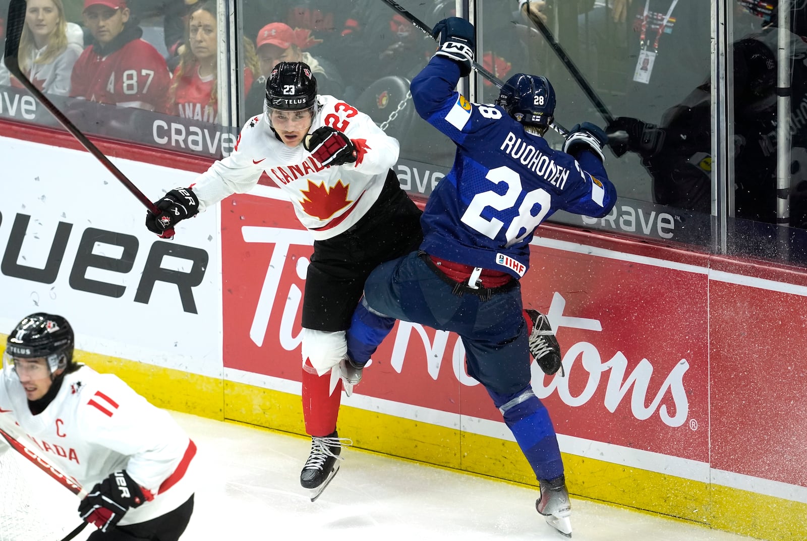 Canada forward Tanner Howe (23) collides with Finland forward Heikki Ruohonen (28) during first period IIHF World Junior Hockey Championship tournament action, Thursday, Dec. 26, 2024, in Ottawa. (Adrian Wyld/The Canadian Press via AP)