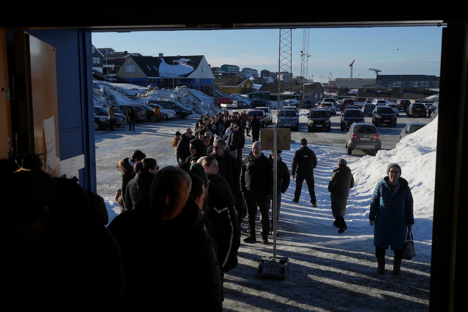 People line up outside a polling station to cast their vote in parliamentary elections, in Nuuk, Greenland, Tuesday, March 11, 2025. (AP Photo/Evgeniy Maloletka)