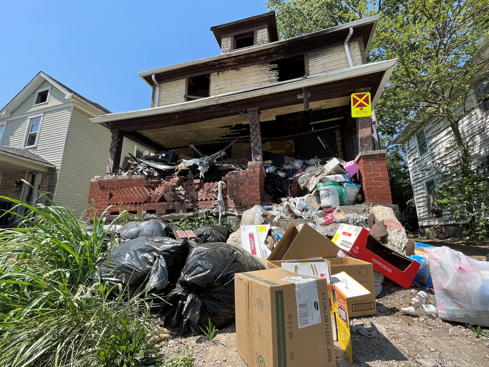 A tax-delinquent home in West Dayton that had a lot of trash in the yard. CORNELIUS FROLIK / STAFF