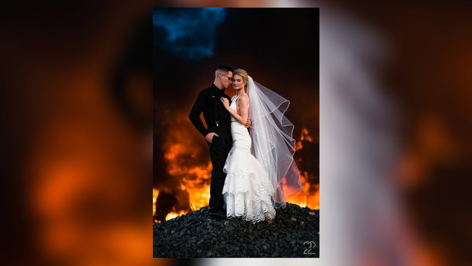 Megan Allen of Studio 22 Photography captures photo of newlyweds Dillon and Corrie Jameson of Troy in front of burning building in Dayton.