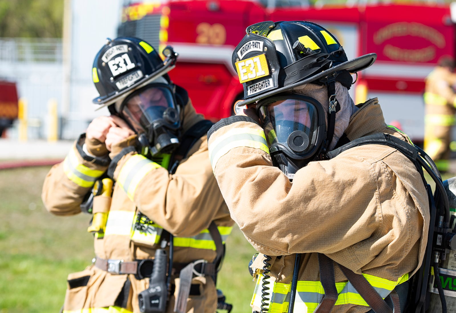 Firefighters from the 788th Civil Engineer Squadron fire department secure their helmets before beginning their aircraft fire-fighting training at Wright-Patterson Air Force Base April 26. U.S. AIR FORCE PHOTO/WESLEY FARNSWORTH