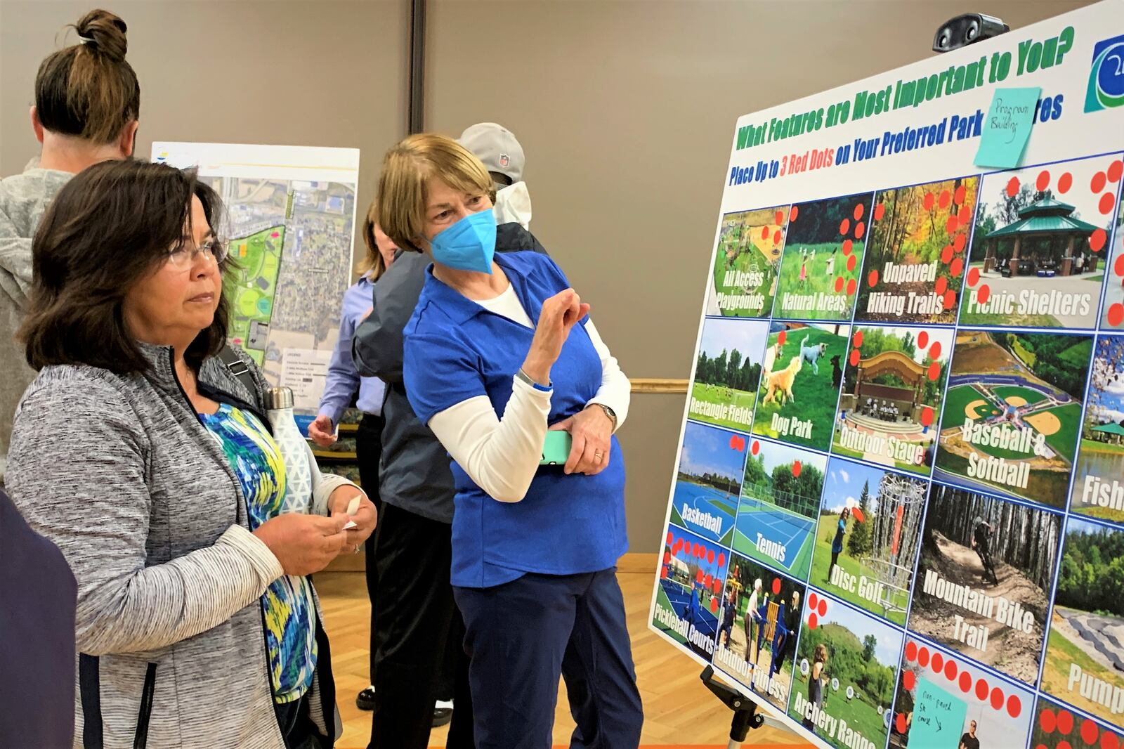 Beavercreek residents review and vote on potential amenities for the city's newest 148-acre park at a public open house Wednesday evening. LONDON BISHOP/STAFF