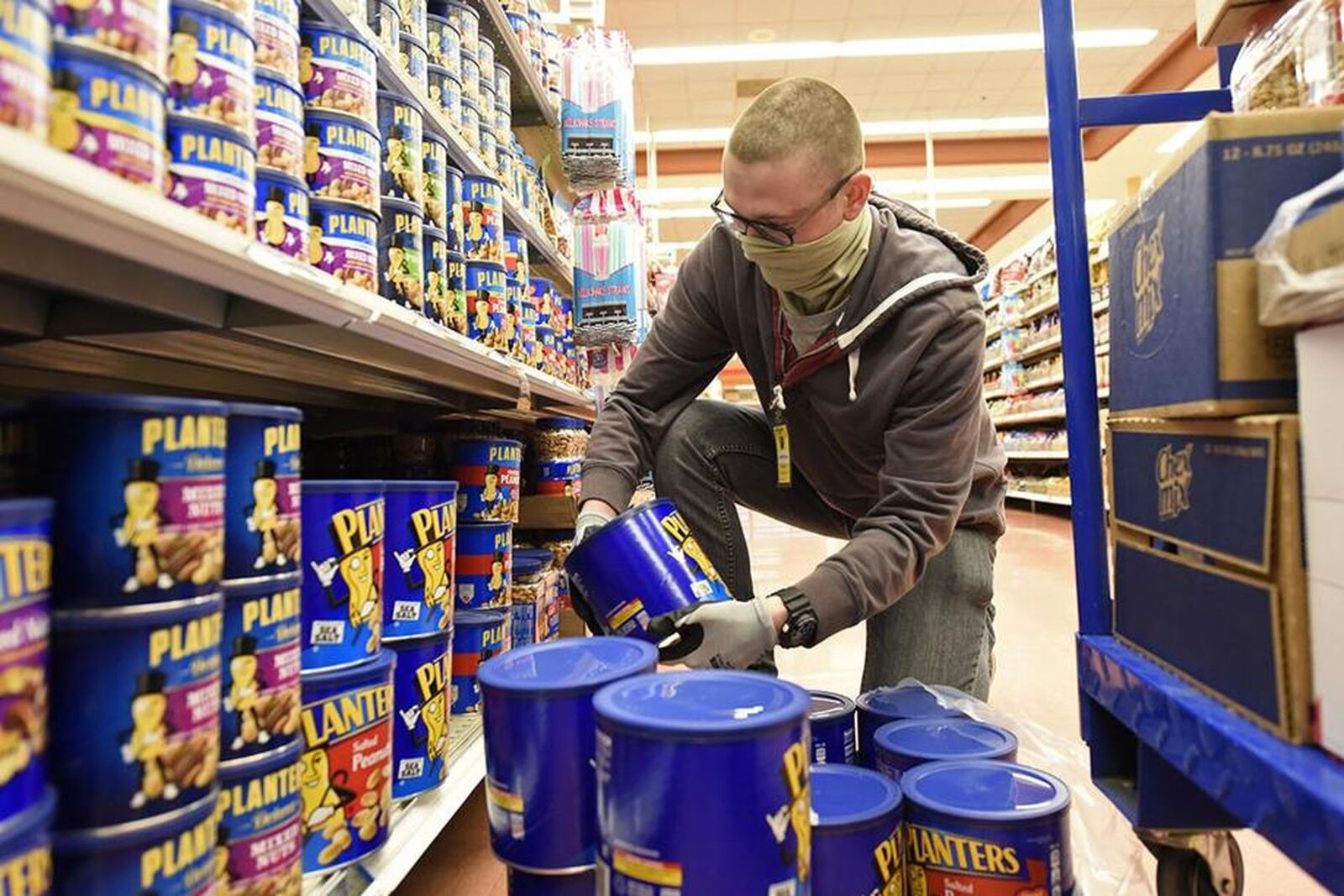 U.S. Air Force Airman Kevin Reed, 88th Air Base Wing Communications Squadron, stocks shelves as a volunteer at the Wright-Patterson Air Force Base commissary on April 9.(U.S. Air Force photo/Ty Greenlees)