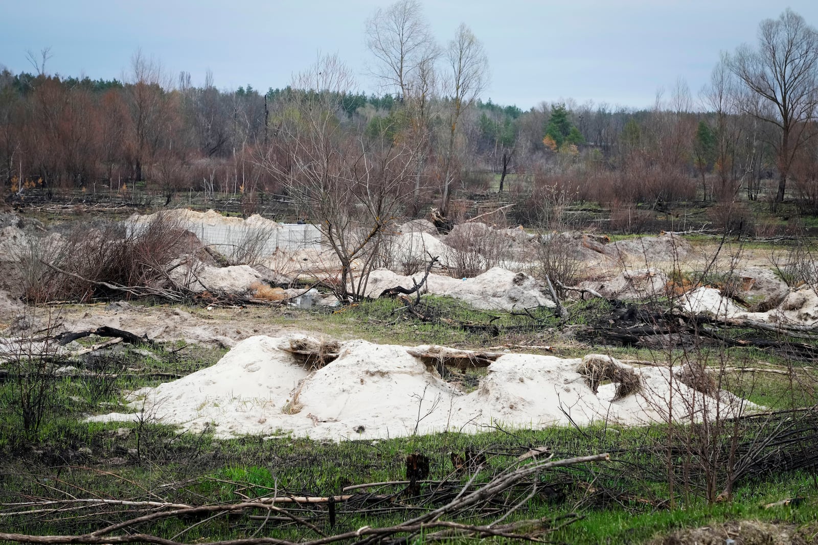 FILE - Russian trenches and firing positions sit in the highly contaminated soil adjacent to the Chernobyl nuclear power plant near Chernobyl, Ukraine, April 16, 2022. (AP Photo/Efrem Lukatsky, File)