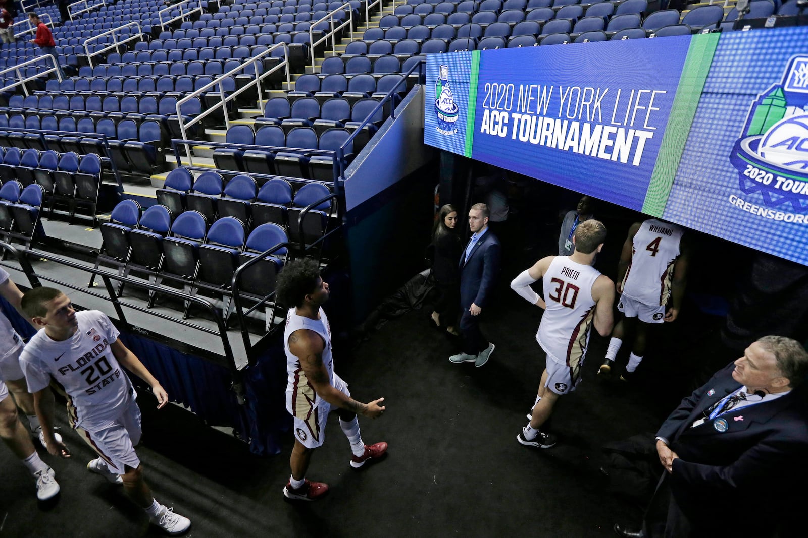 FILE - Florida State players leave the court after the NCAA college basketball games at the Atlantic Coast Conference tournament were canceled due to coronavirus concerns, Thursday, March 12, 2020, in Greensboro, N.C. (AP Photo/Gerry Broome, File)