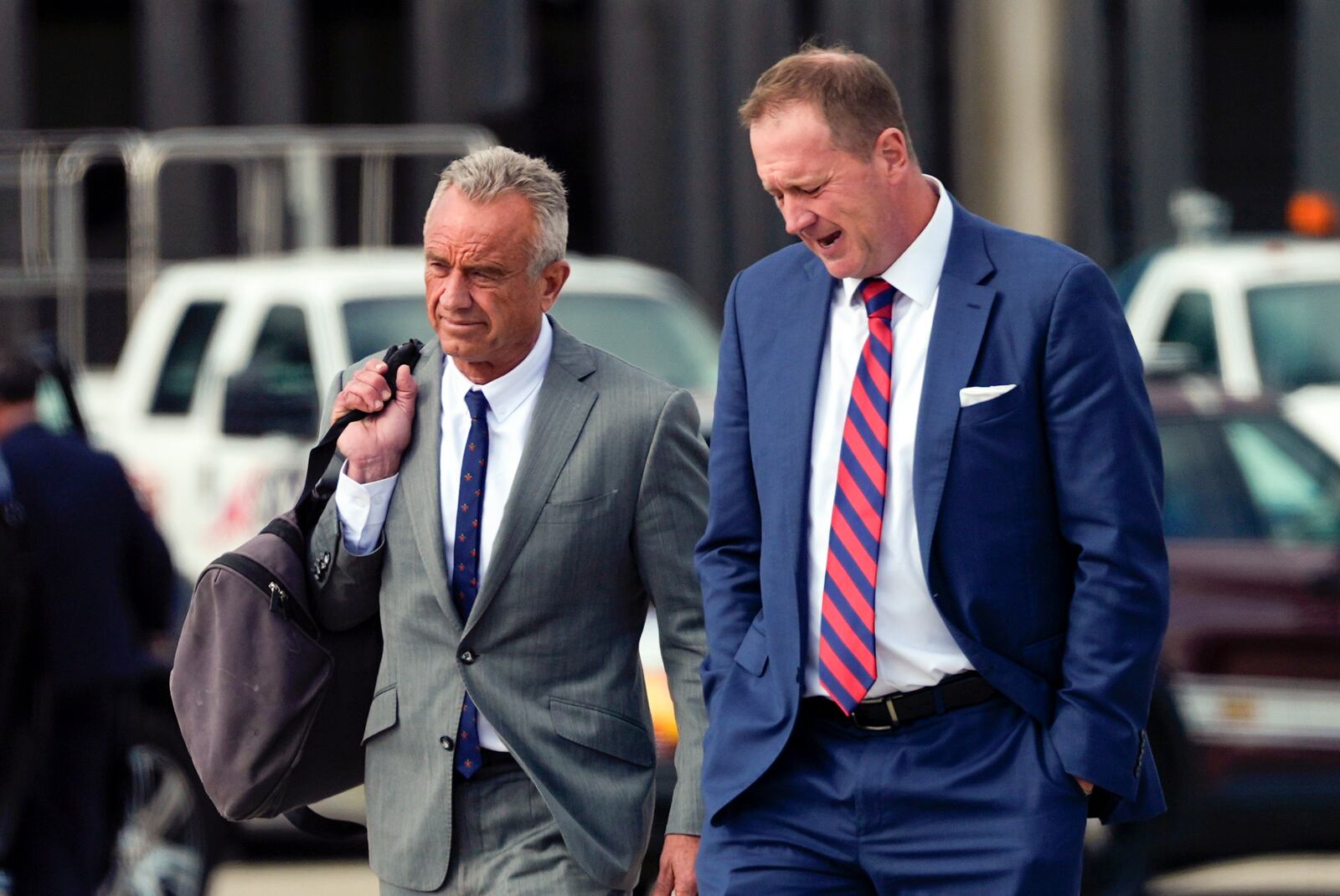 Robert F. Kennedy Jr., walks on the tarmac as Republican presidential nominee former President Donald Trump arrives at Detroit Metropolitan Wayne County Airport, Friday, Nov. 1, 2024, in Romulus, Mich. (AP Photo/Julia Demaree Nikhinson)