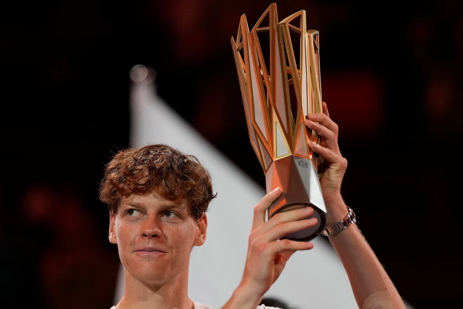 Jannik Sinner of Italy celebrates with his trophy after defeating Novak Djokovic of Serbia in the men's singles finals match for the Shanghai Masters tennis tournament at Qizhong Forest Sports City Tennis Center in Shanghai, China, Sunday, Oct. 13, 2024. (AP Photo/Andy Wong)