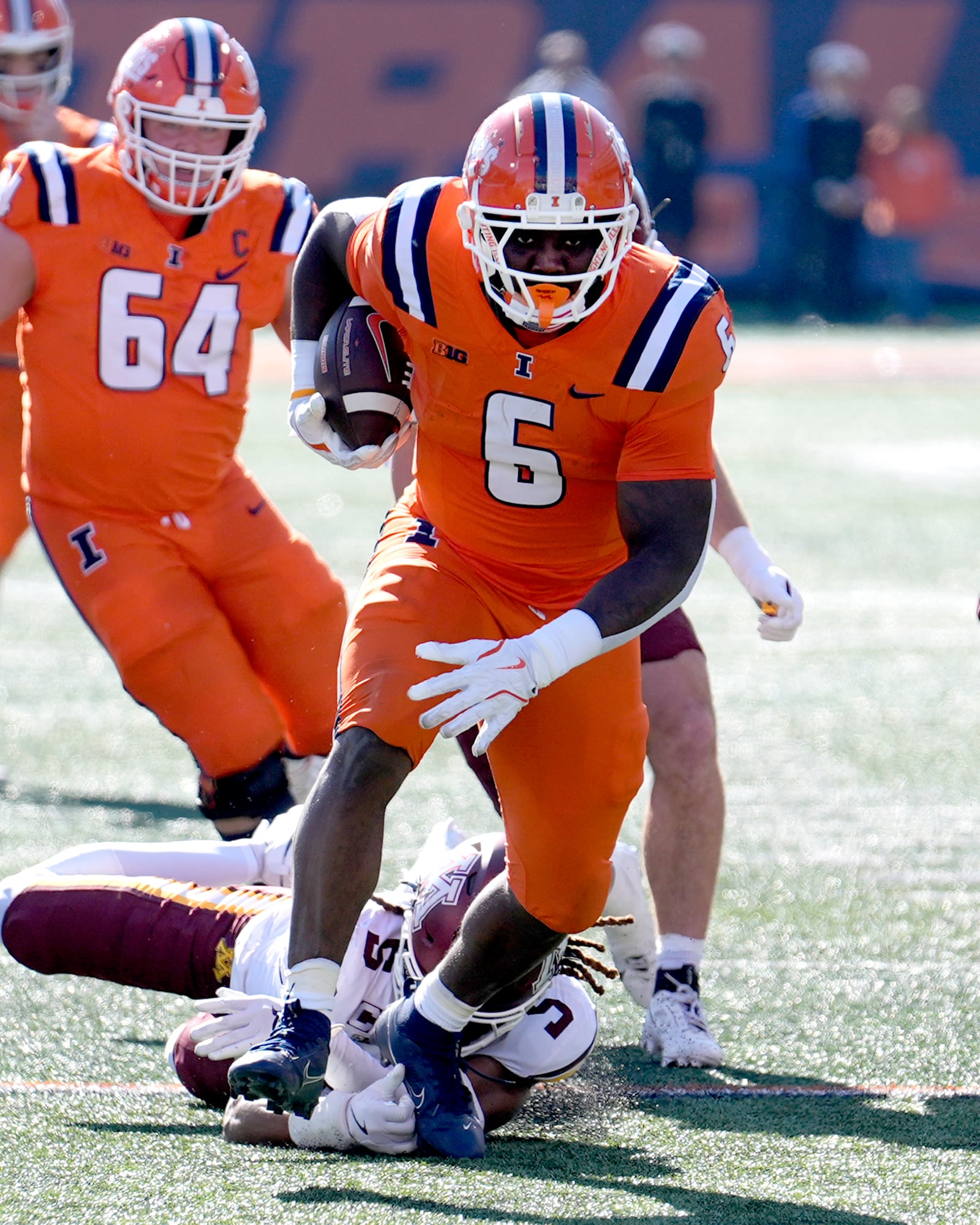 Illinois running back Josh McCray catties the ball during the first half of an NCAA college football game against Minnesota on Saturday, Nov. 2, 2024, in Champaign, Ill. (AP Photo/Charles Rex Arbogast)