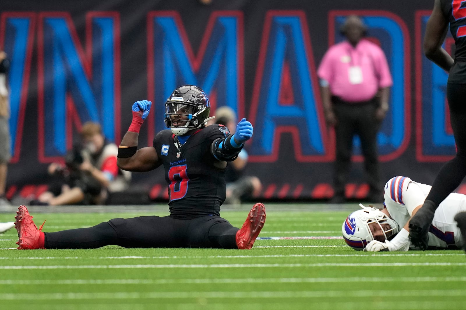 Houston Texans linebacker Azeez Al-Shaair (0) celebrates after tackling Buffalo Bills quarterback Josh Allen, right, during the second half of an NFL football game, Sunday, Oct. 6, 2024, in Houston. (AP Photo/Eric Gay)