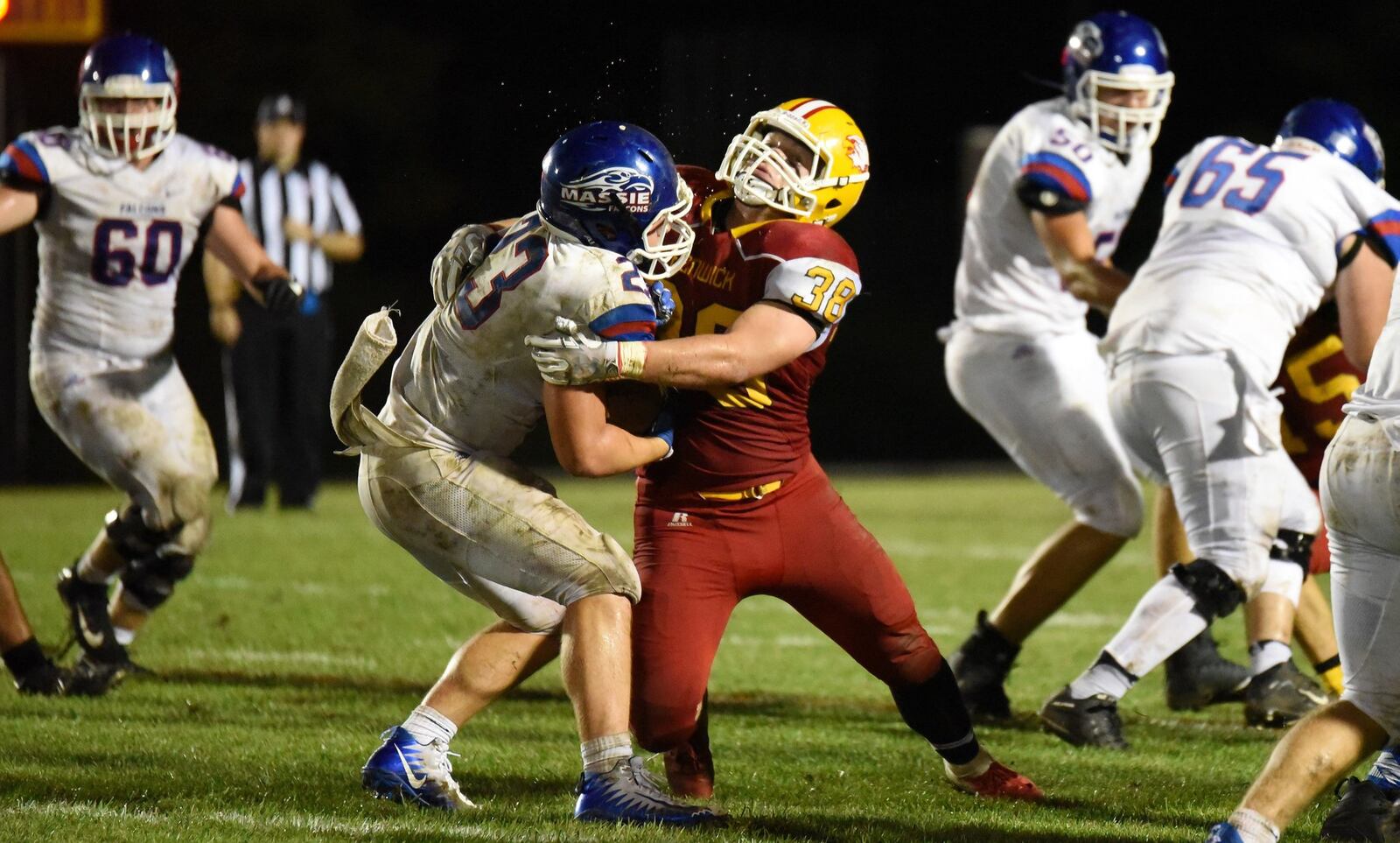 Fenwick’s John Stevenson (38) puts a hit on Clinton-Massie tailback Brendan Lamb during Friday night’s game at Krusling Field in Middletown. Visiting C-M won 21-18. CONTRIBUTED PHOTO BY ANGIE MOHRHAUS