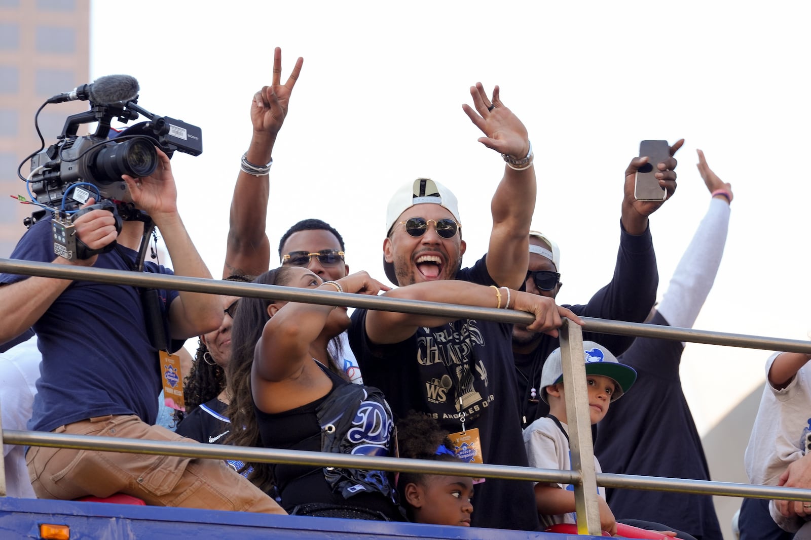 Los Angeles Dodgers' Mookie Betts waves at fans during the Los Angeles Dodgers baseball World Series championship parade Friday, Nov. 1, 2024, in Los Angeles. (AP Photo/Jae C. Hong)