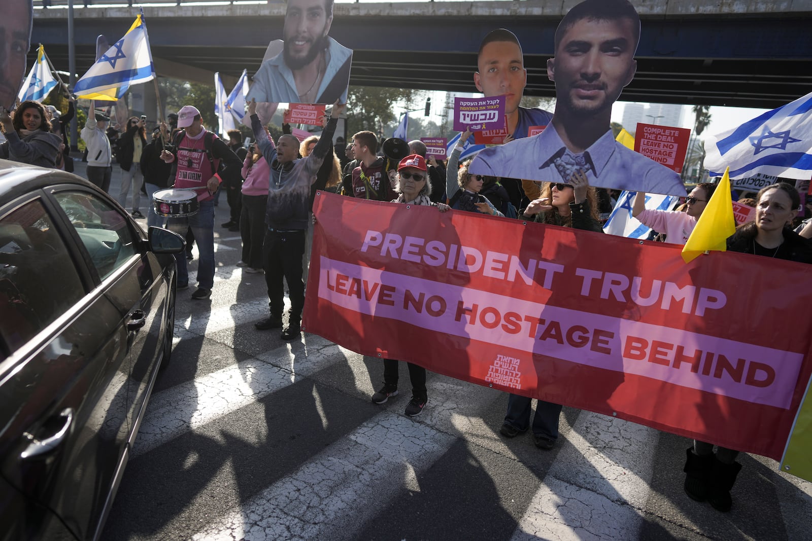 Relatives and supporters of Israelis held hostage in the Gaza Strip, block a freeway during a protest demanding their release from Hamas captivity as they mark 500 days of the Israel-Hamas war in Tel Aviv, Israel, Monday, Feb. 17, 2025. (AP Photo/Oded Balilty)