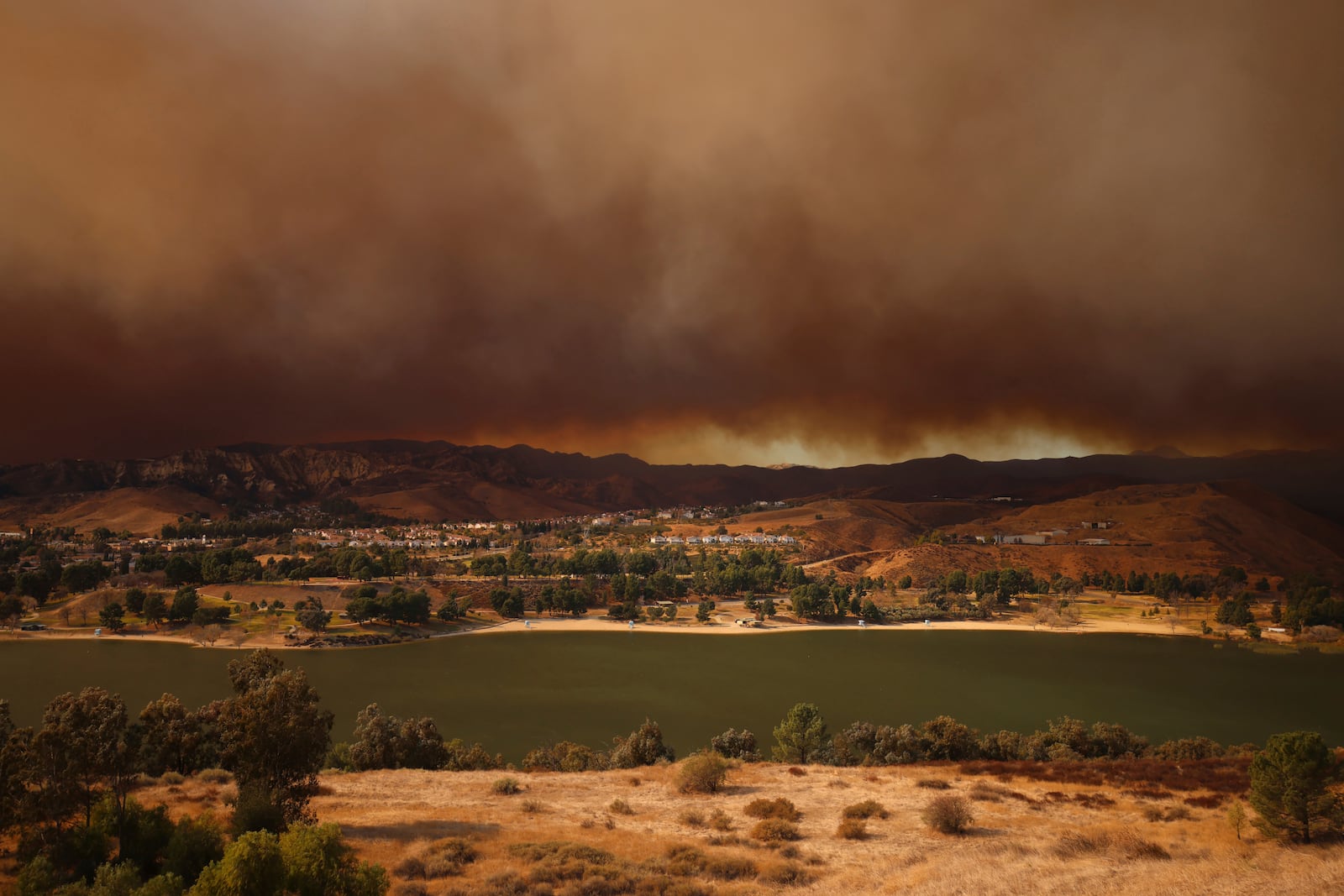 Plumes of smoke caused by the Hughes Fire rise over Castaic, Calf., Wednesday, Jan. 22, 2025. (AP Photo/Ethan Swope)