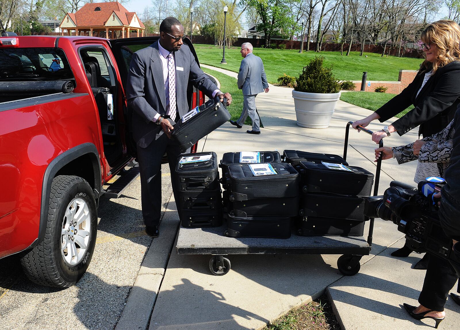 Members of the Omega Baptist Church and the Haines Children's Center unload 50 new suitcases full of hygiene products for local foster children, who often must pack their belongings in plastic bags because they do not have suitcases. April 27, 2022. MARSHALL GORBY\STAFF