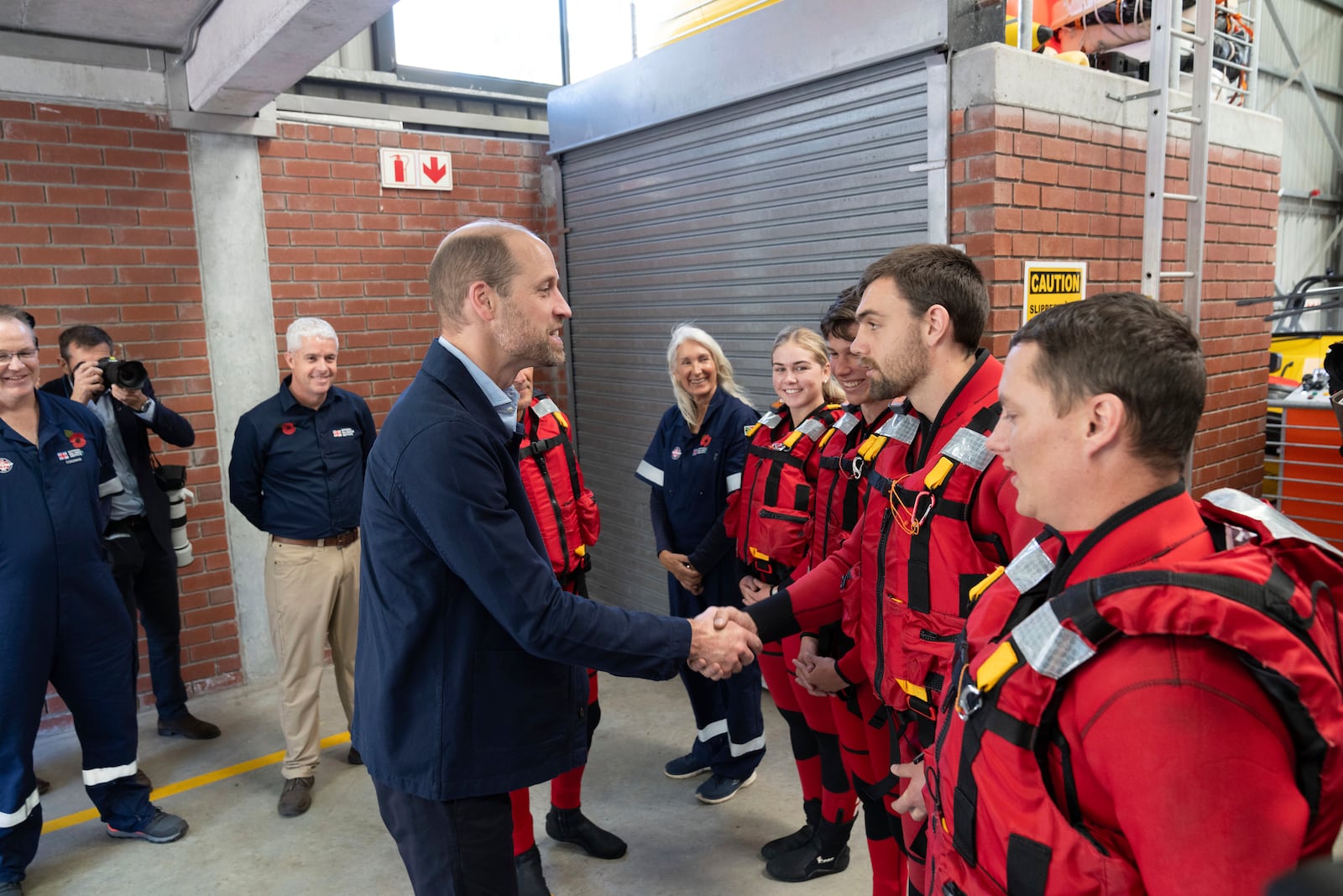 Britain's Prince William meets volunteers of the National Sea Rescue Initiative at Simon's Town harbour in Cape Town, South Africa, Thursday, Nov. 7, 2024. (AP Photo/Jerome Delay, Pool)