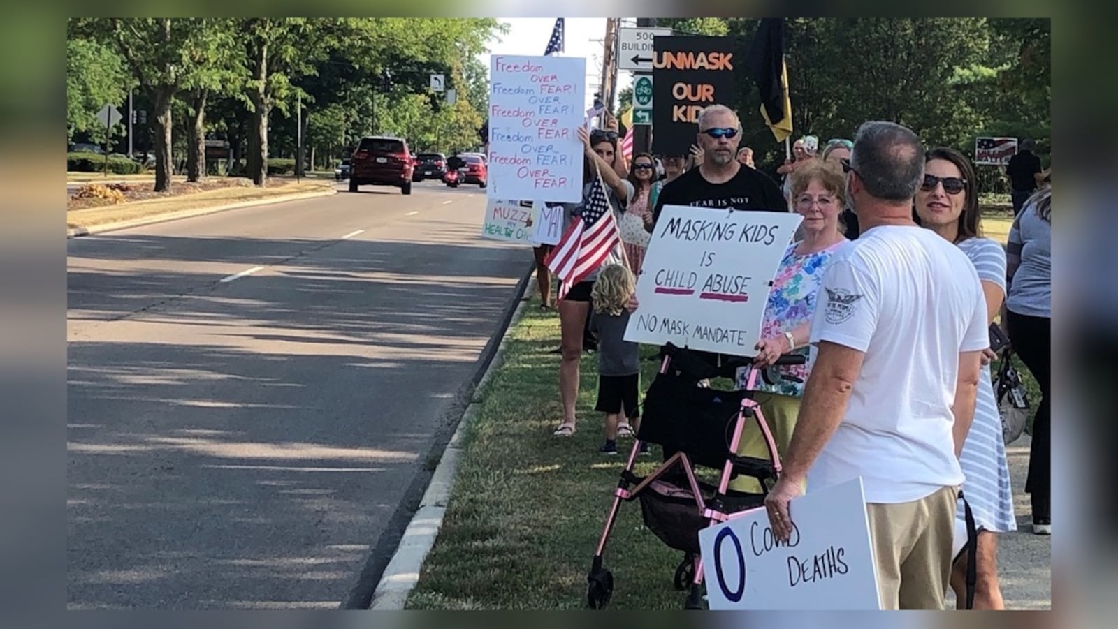 Protesters held signs against a mask mandate for Kettering students before Tuesday evening's school board meeting. Superintendent Scott Inskeep was expected to propose face masks for all students amid increasing COVID-19 cases  and quarantines in the district, which started school Aug. 12 with masks optional. Nick Blizzard/Staff