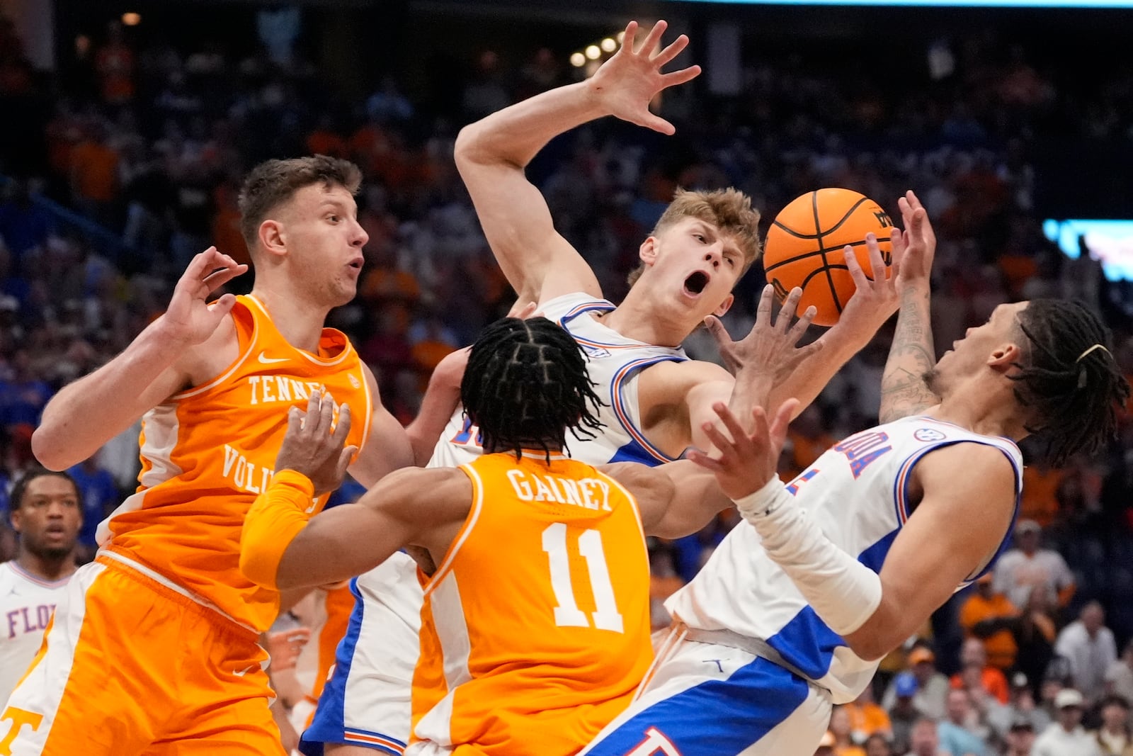 Florida forward Thomas Haugh (10) and Florida guard Denzel Aberdeen (11) chase a loose ball during the second half of an NCAA college basketball game in the final round of the Southeastern Conference tournament, Sunday, March 16, 2025, in Nashville, Tenn. (AP Photo/George Walker IV)