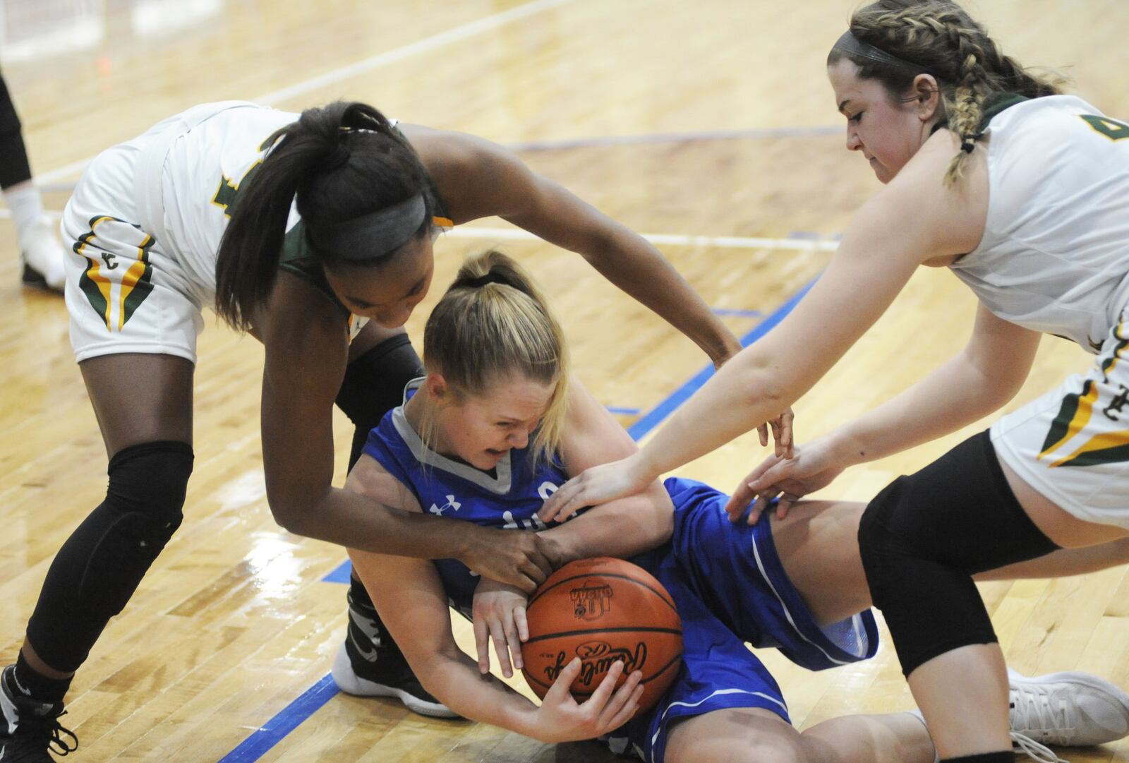 Chloe Peters (with ball) of Franklin Monroe draws Troy Christian defenders Alexis Salazar (left) and Jalyn Forrer. Franklin Monroe defeated Troy Christian 43-28 in a D-IV girls high school basketball sectional semifinal at Brookville on Wednesday, Feb. 20, 2019. MARC PENDLETON / STAFF