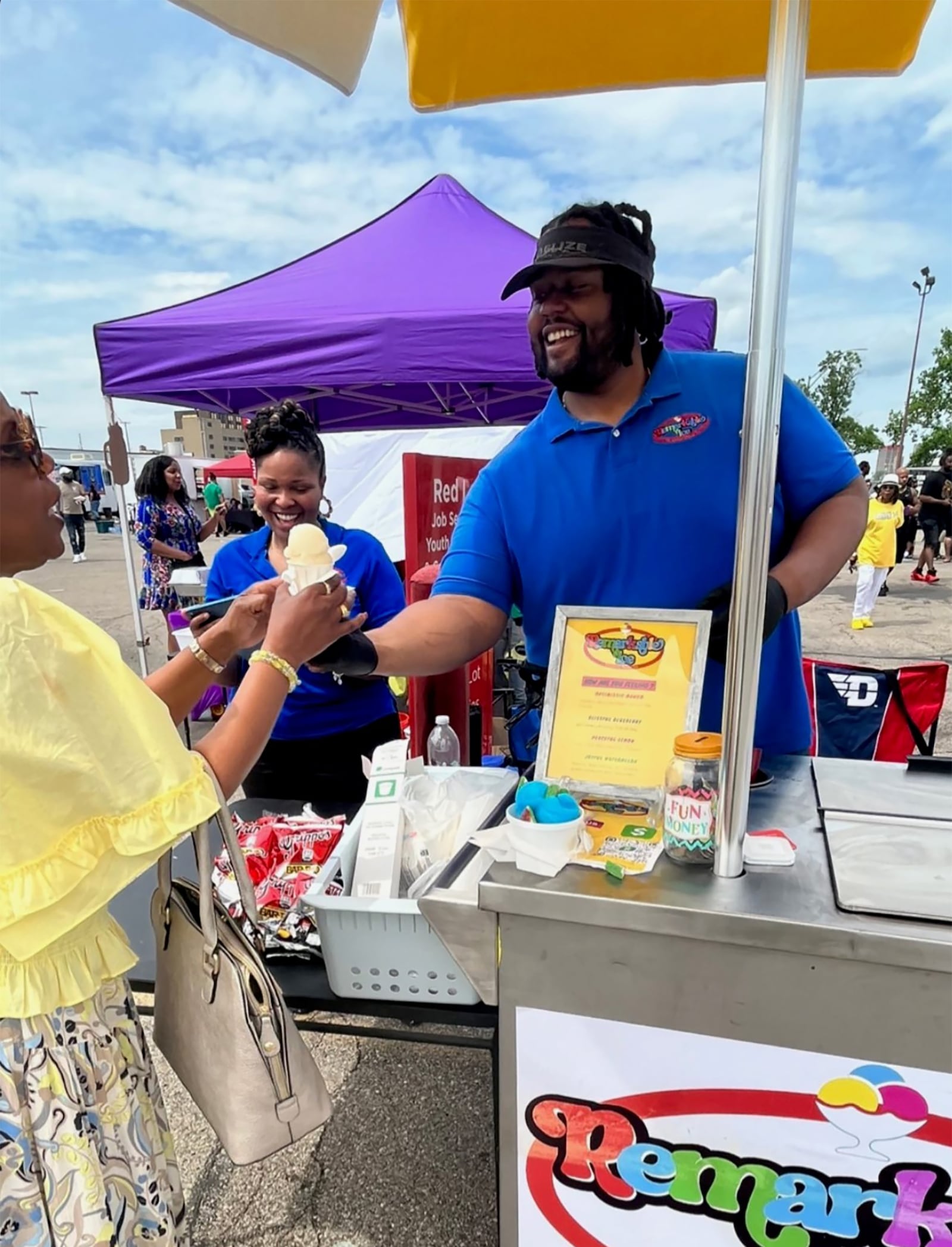 Keenan Woods, right, with his fiancée Roe Wallace serving his "Remarkable Ice" to a customer. The couple plan to get married in May. CONTRIBUTED