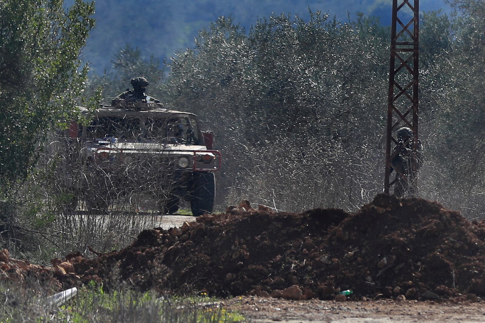 Israeli soldiers take their positions as they block a road leading to the southern Lebanese village of Kfar Kila, Lebanon, Sunday, Feb. 2, 2025.(AP Photo/Mohammed Zaatari)