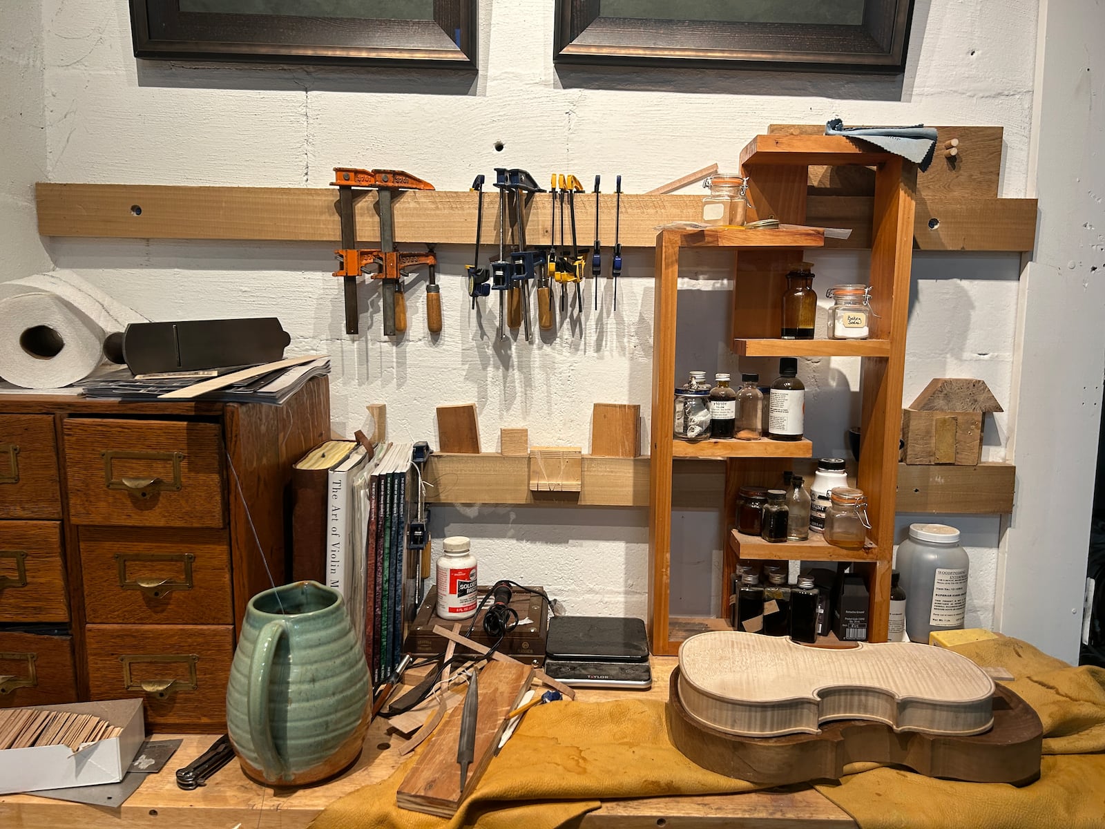 A workbench with tools and a raw violin in Joel Thompson's workshop. "One of the first things we do in violin school is make our own bench knives and handles.”