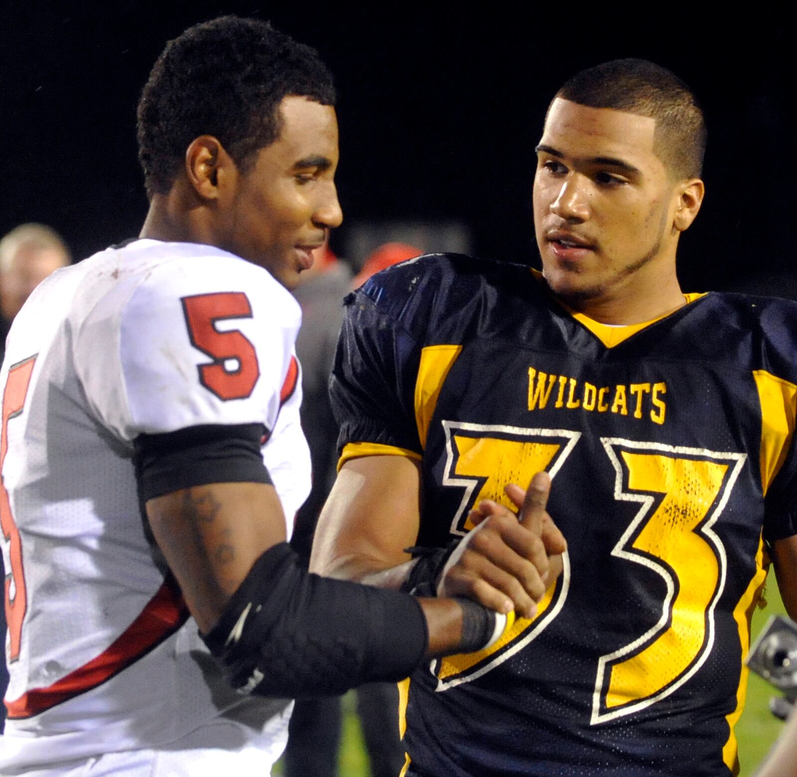 Former teammates Braxton Miller, Wayne's quarterback, and Springfield's Trey DePriest shake hands after their final game of the 2009 season. Miller grew up in Springfield and played junior high ball with DePriest