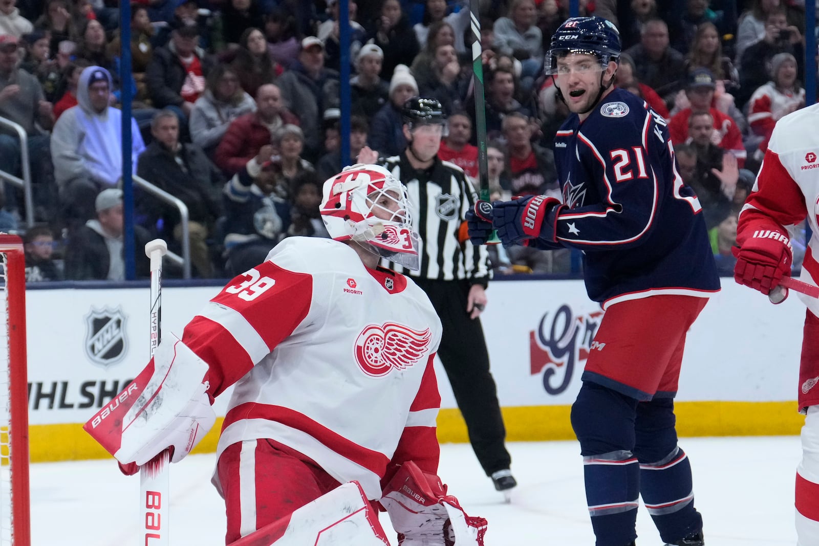 Columbus Blue Jackets left wing James van Riemsdyk (21) celebrates a goal by teammate Zach Werenski in front of Detroit Red Wings goaltender Cam Talbot (39) in the second period of an NHL hockey game in Columbus, Ohio, Thursday, Jan. 2, 2025. (AP Photo/Sue Ogrocki)