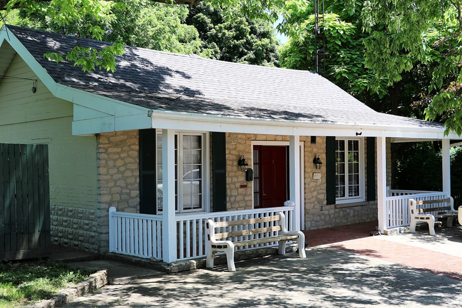 A covered front porch accents the craftsman workshop and garage. The stone front matches the other two building but inside, the front door is a workshop area designed for all the professional tools and equipment. CONTRIBUTED PHOTO BY KATHY TYLER