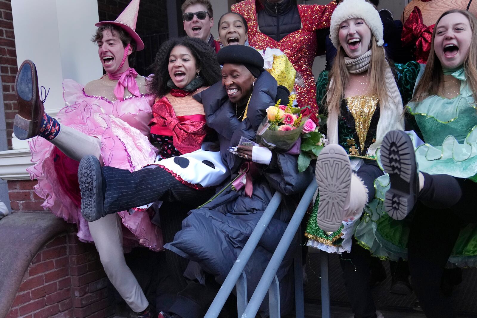 Cynthia Erivo, center, Harvard University's Hasty Pudding Theatricals Woman of the Year, dances while flanked by character actors following a parade in her honor, Wednesday, Feb. 5, 2025, in Cambridge, Mass. (AP Photo/Charles Krupa)