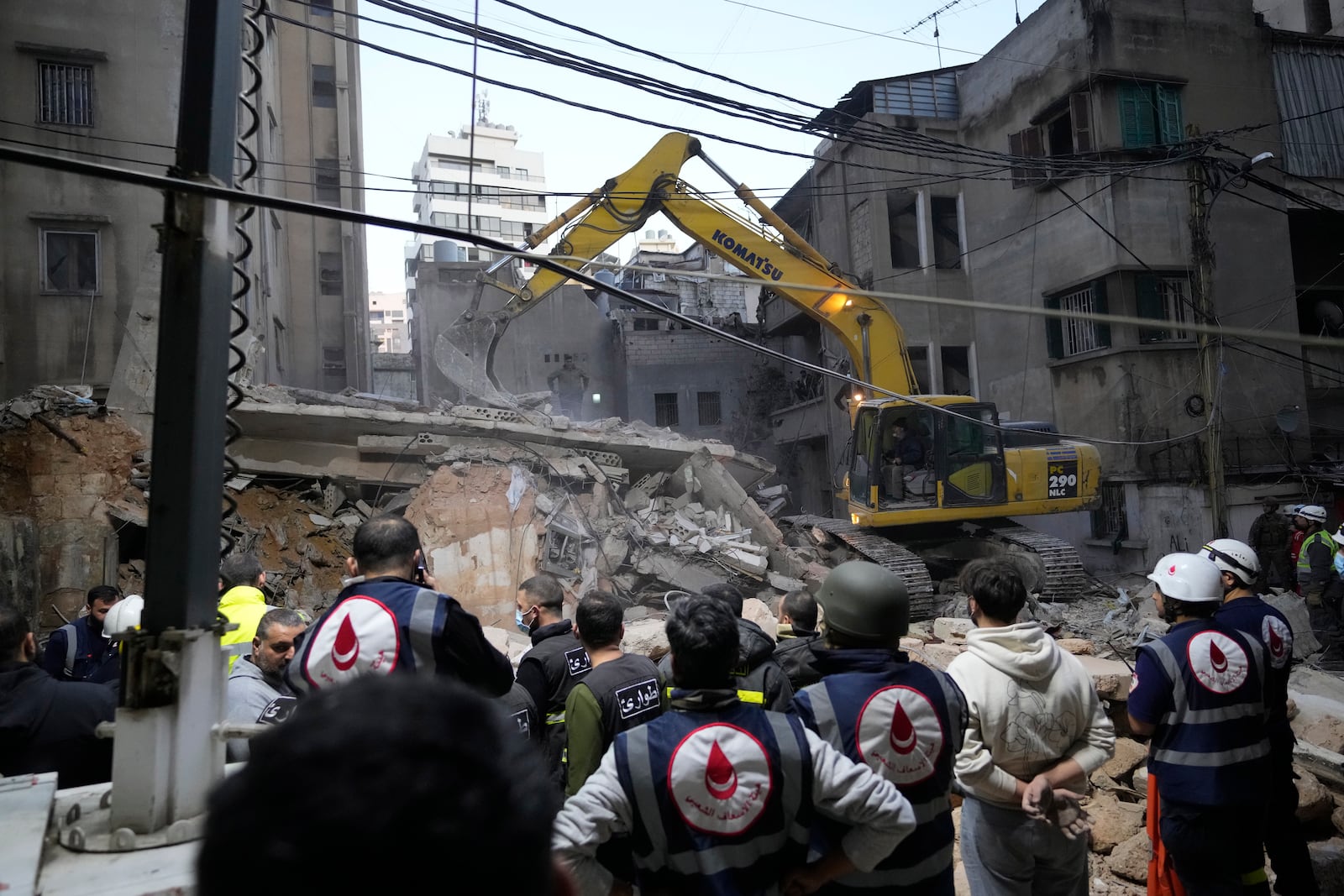 Rescuers use an excavator as they search for victims at the site of an Israeli airstrike that targeted a building in Beirut, Lebanon, Tuesday, Nov. 26, 2024. (AP Photo/Hassan Ammar)