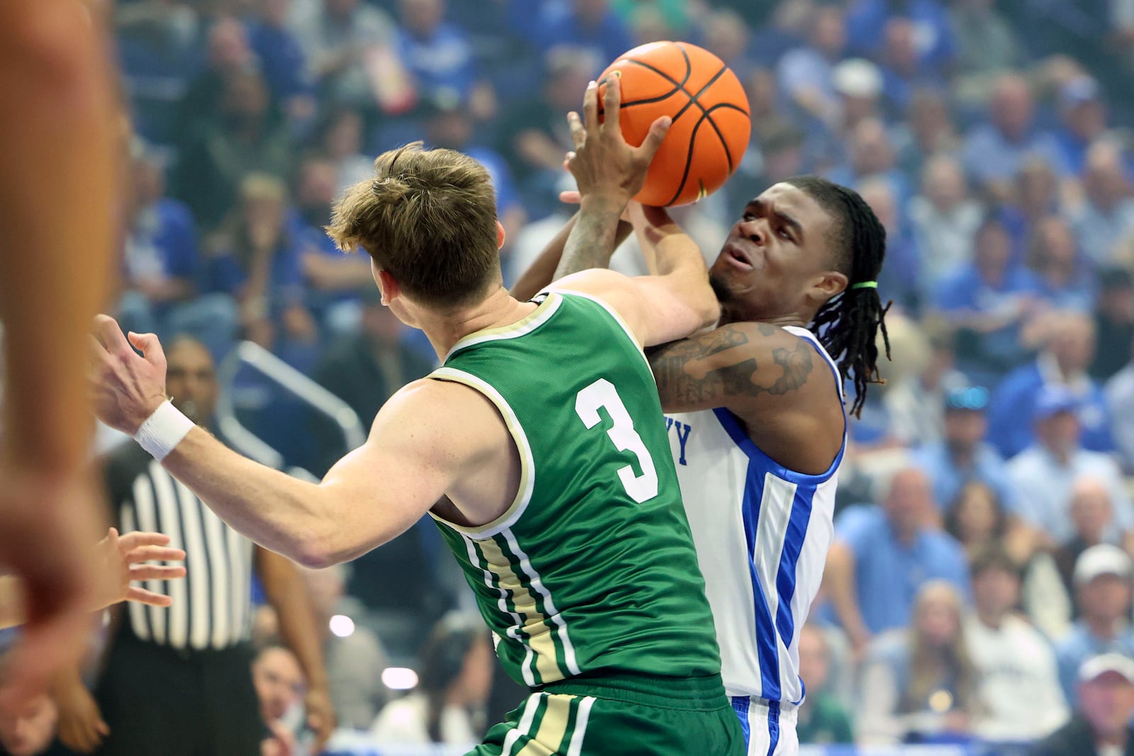 Kentucky's Otega Oweh, right, gets tied up with Wright State's Alex Huibregtse (3) during the first half of an NCAA college basketball game in Lexington, Ky., Monday, Nov. 4, 2024. (AP Photo/James Crisp)