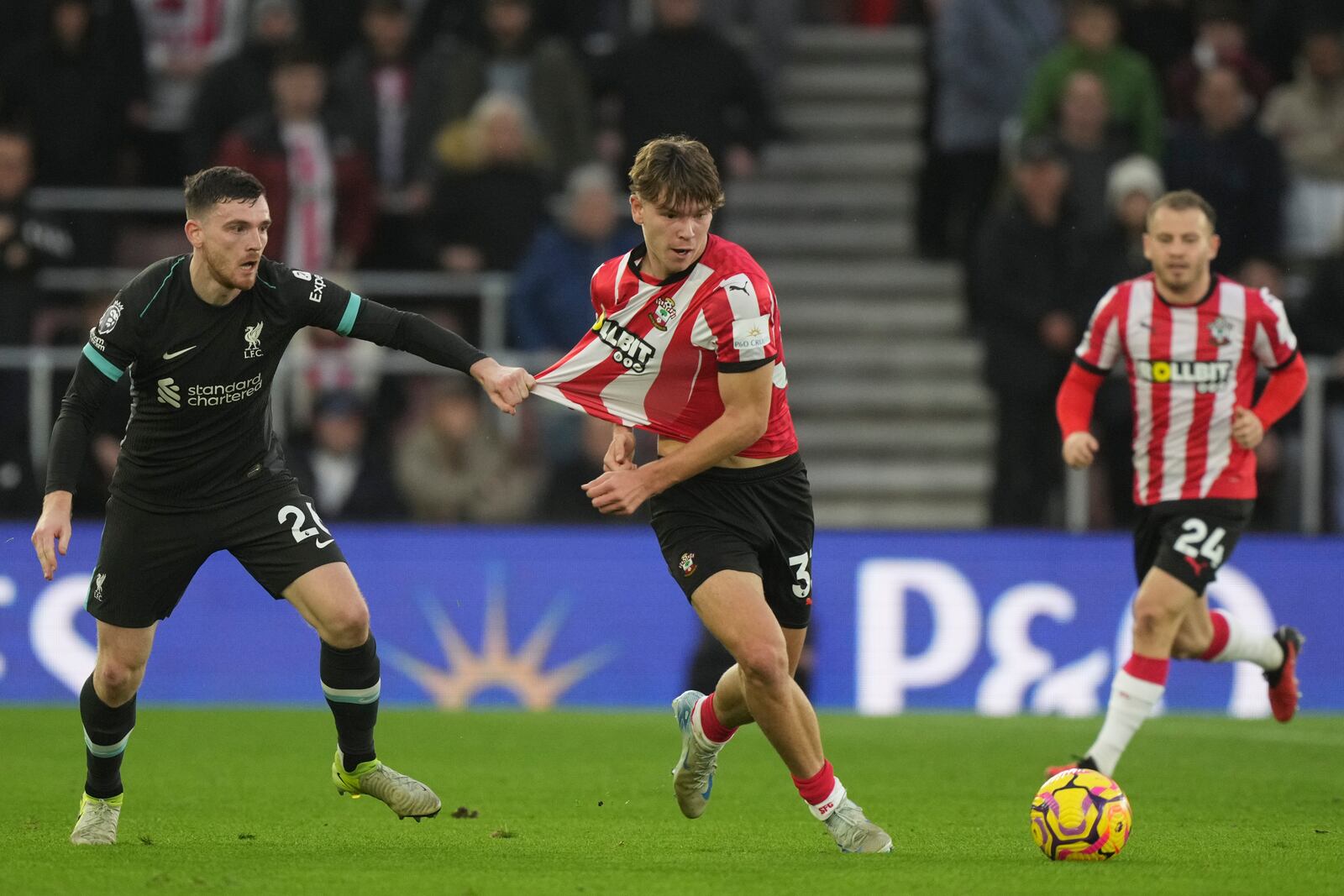 Liverpool's Andrew Robertson holds Southampton's Tyler Dibling during the English Premier League soccer match between Southampton and Liverpool in Southampton, England, Sunday, Nov. 24, 2024. (AP Photo/Sean Ryan)