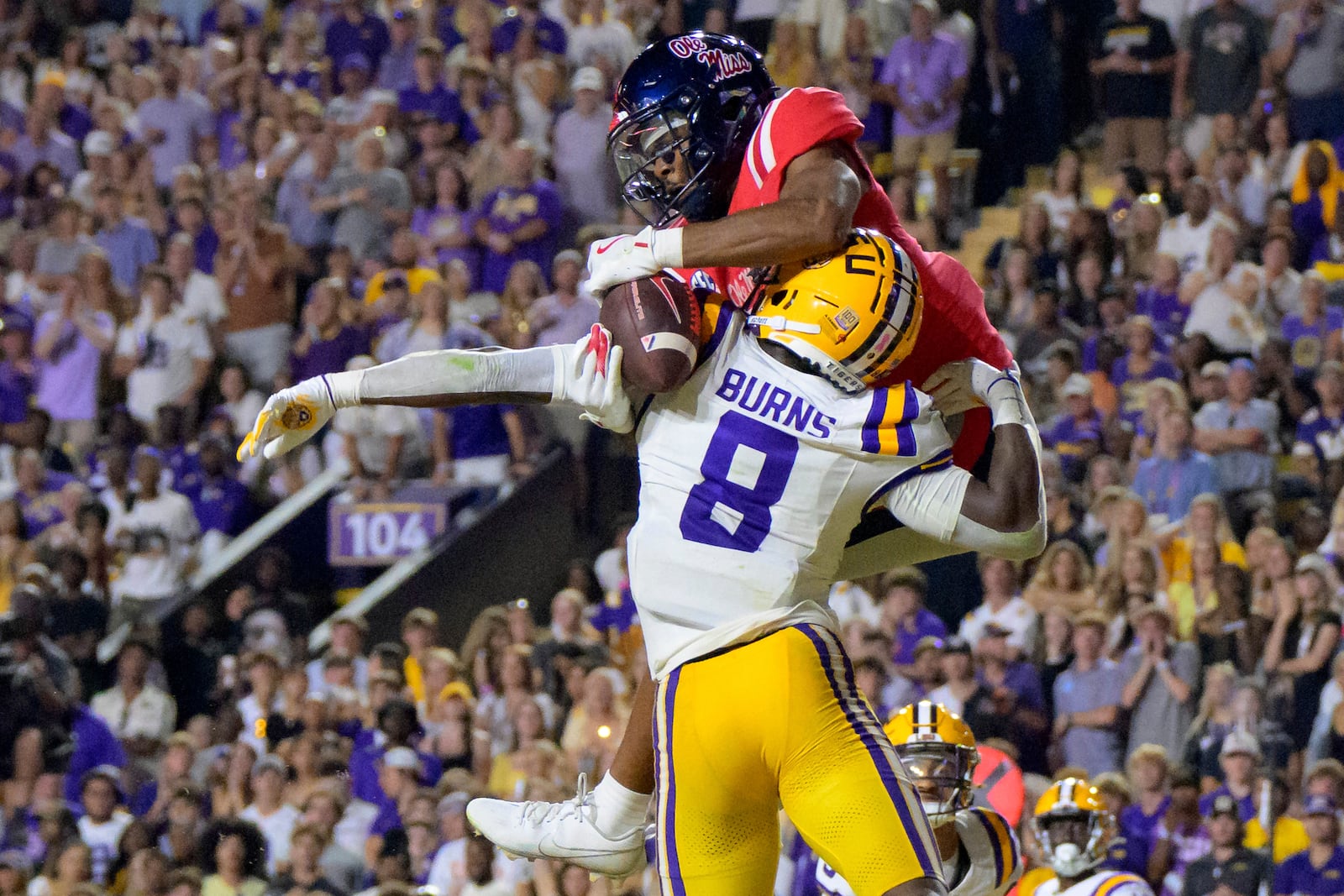 Mississippi wide receiver Tre Harris (9) makes a touchdown reception in the end zone against LSU safety Major Burns (8) during the first half of an NCAA college football game in Baton Rouge, La., Saturday, Oct. 12, 2024. (AP Photo/Matthew Hinton)