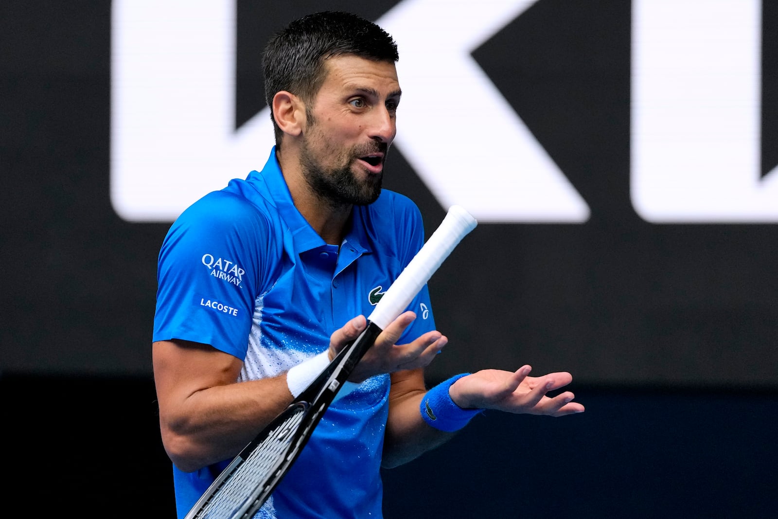 Novak Djokovic of Serbia reacts during his second round match against Jaime Faria of Portugal at the Australian Open tennis championship in Melbourne, Australia, Wednesday, Jan. 15, 2025. (AP Photo/Vincent Thian)