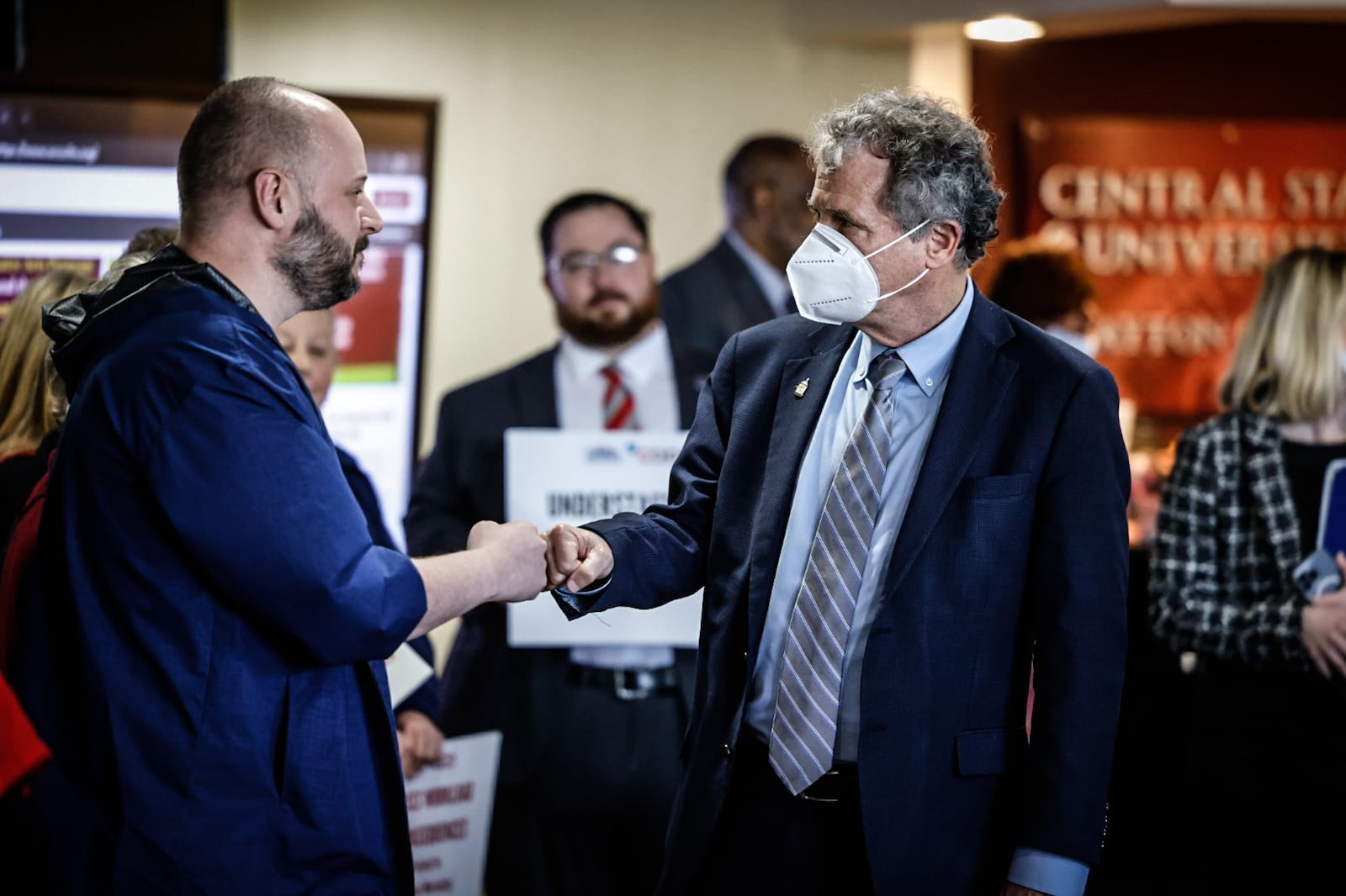 Ohio Sen. Sherrod Brown fist pumps Wexner Medical Center at OSU nurse, Rick Lucas at a press conference Tuesday April 11, 2023 at Central State West Campus. Senator Brown is co-sponsoring a bill in congress called the nurse staffing standards for hospital patient safety and quality act. JIM NOELKER/STAFF