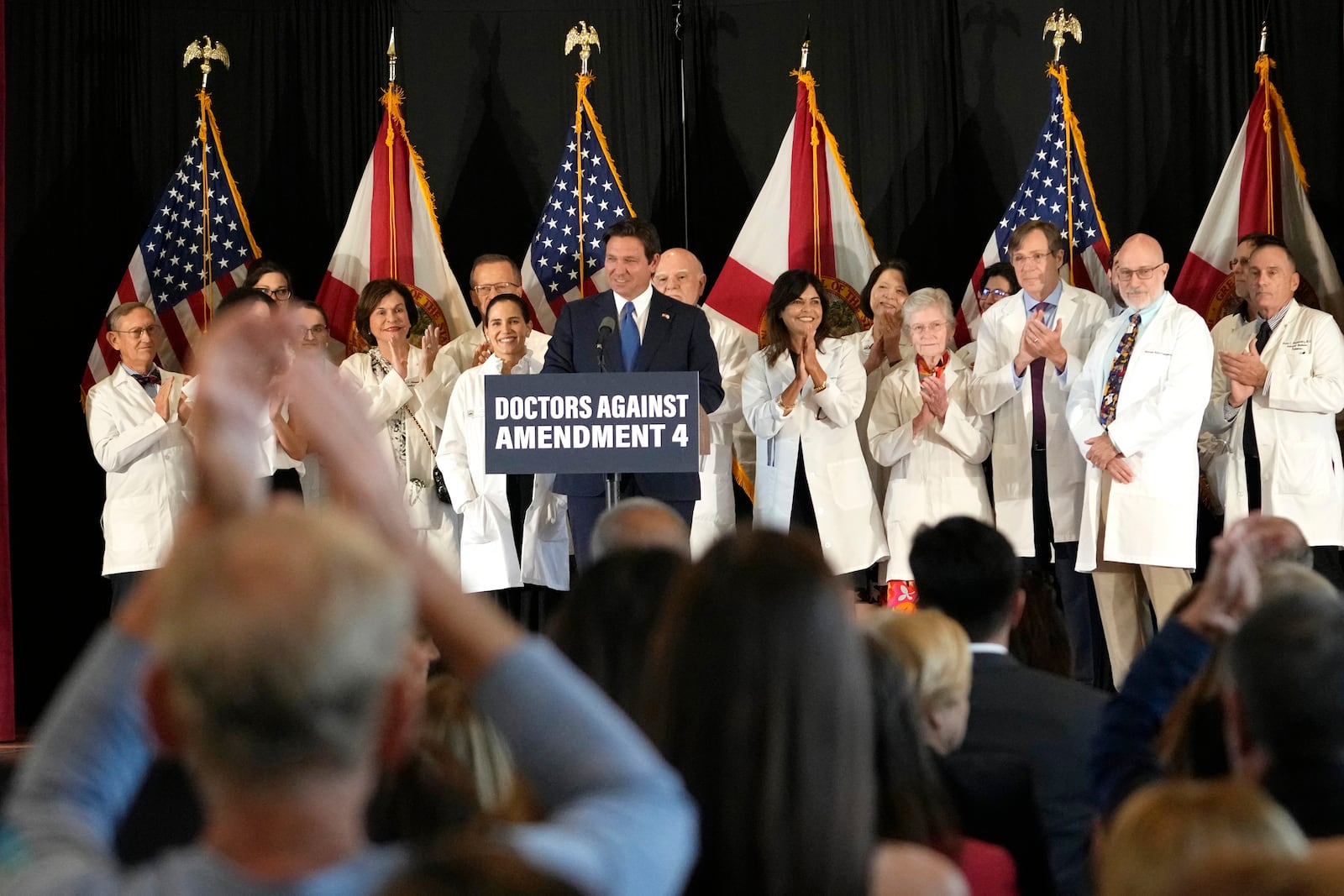 People applaud as Florida Gov. Ron DeSantis speaks out against Amendment 4 which would protect access to abortion during a news conference with Florida Physicians Against Amendment 4 Monday, Oct. 21, 2024, in Coral Gables, Fla. (AP Photo/Lynne Sladky)