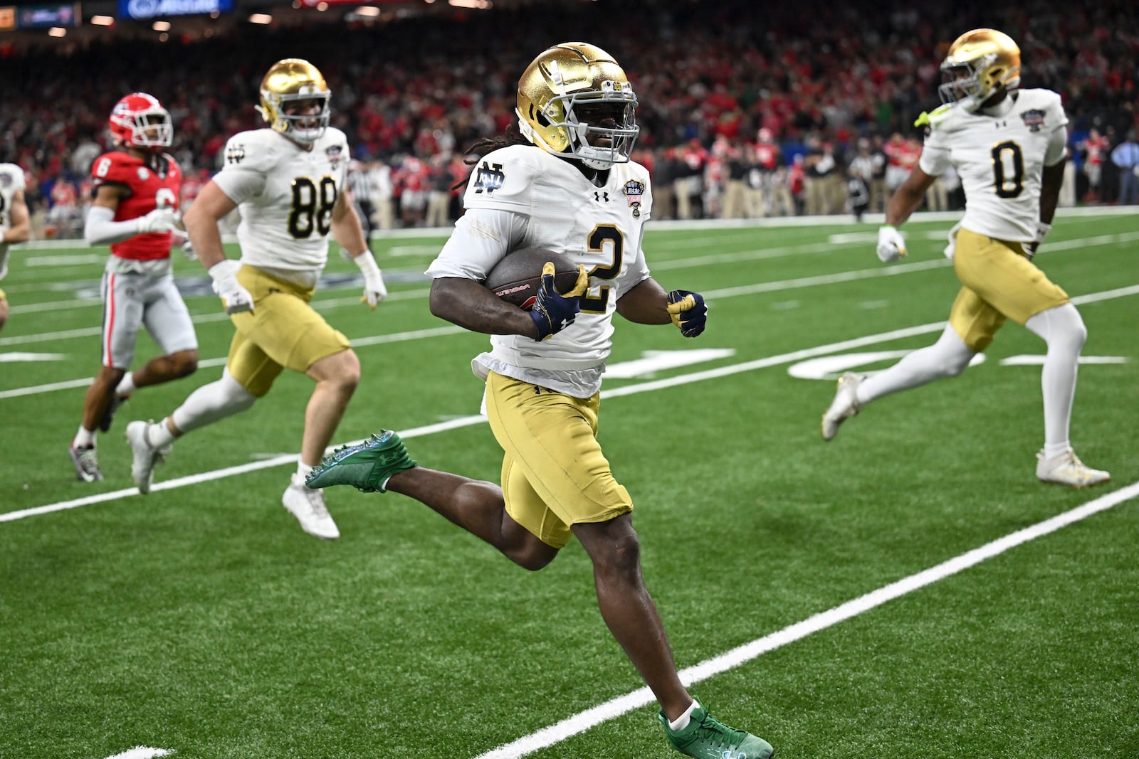 Notre Dame's Jayden Harrison (2) returns a kickoff 98 yards for a touchdown during the second half against Georgia in the quarterfinals of a College Football Playoff, Thursday, Jan. 2, 2025, in New Orleans. (AP Photo/Matthew Hinton)