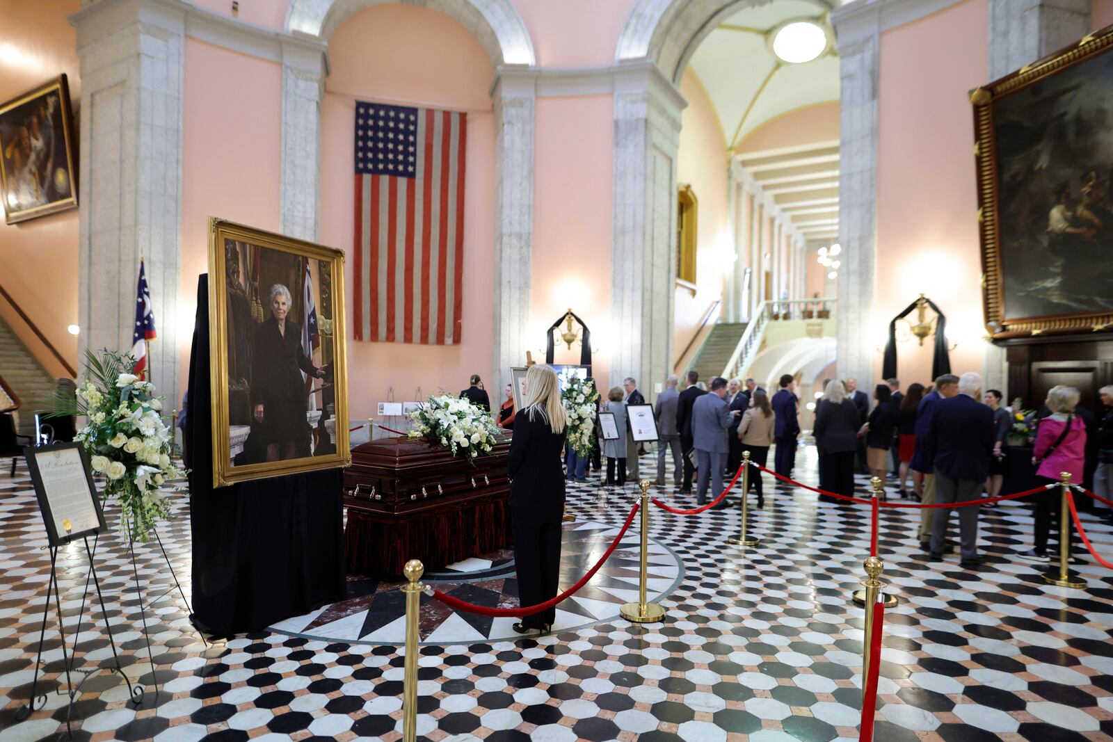 A mourner pauses at the casket for former Ohio speaker of the house Jo Ann Davidson as it lie in state in the rotunda of the Ohio Sate House in Columbus, Ohio, Thursday, Oct. 31, 2024. (AP Photo/Paul Vernon).