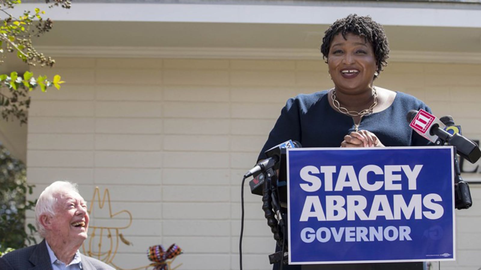 Former President Jimmy Carter listens as Georgia Gubernatorial Democratic candidate Stacey Abrams speaks during a campaign stop at Mercer Medicine at Plains health clinic in September. Abrams has made expansion of Medicaid one of her top priorities.