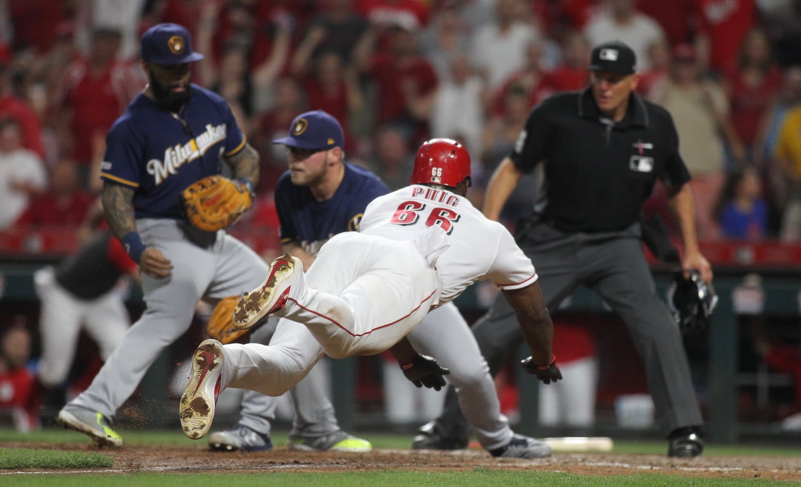 Photos: Reds beat Brewers on wild play in 11th