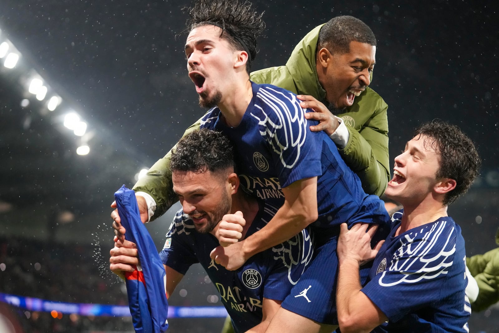 PSG's Goncalo Ramos, bottom left, celebrates with teammates after scoring his side's fourth goal during the Champions League opening phase soccer match between Paris Saint-Germain and Manchester City at the Parc des Princes in Paris, Wednesday, Jan. 22, 2025. (AP Photo/Michel Euler)