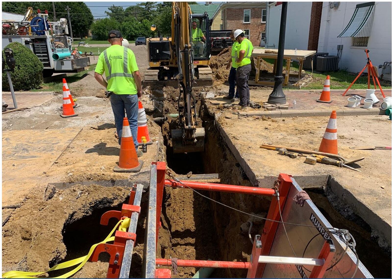 Lebanon Public Works crews work extremely hot weather Wednesday as they install a sanitary sewer line for a new public restroom on Mechanic Street. ED RICHTER/STAFF