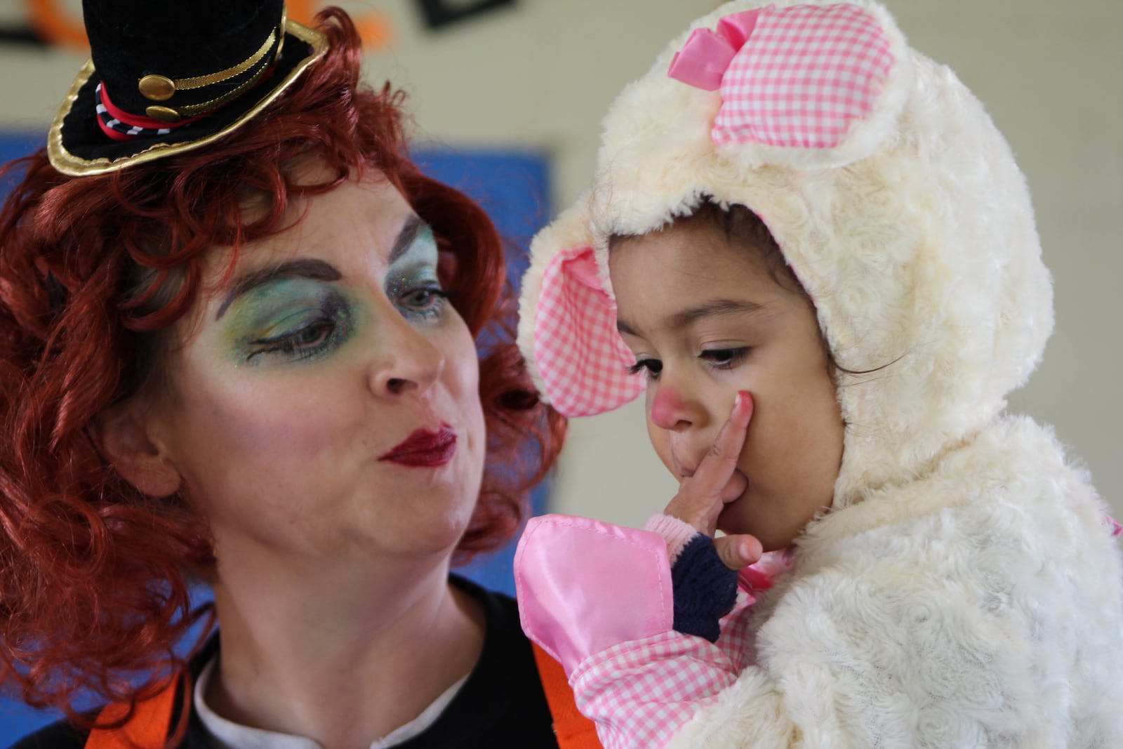 Misty Thomas-Trout, vice president of the DeWeese Ridgecrest Youth Ambassadors, holds her daughter, Nouveau, while at Ridgecrest Park on Sunday. The park had a ribbon-cutting. CORNELIUS FROLIK / STAFF