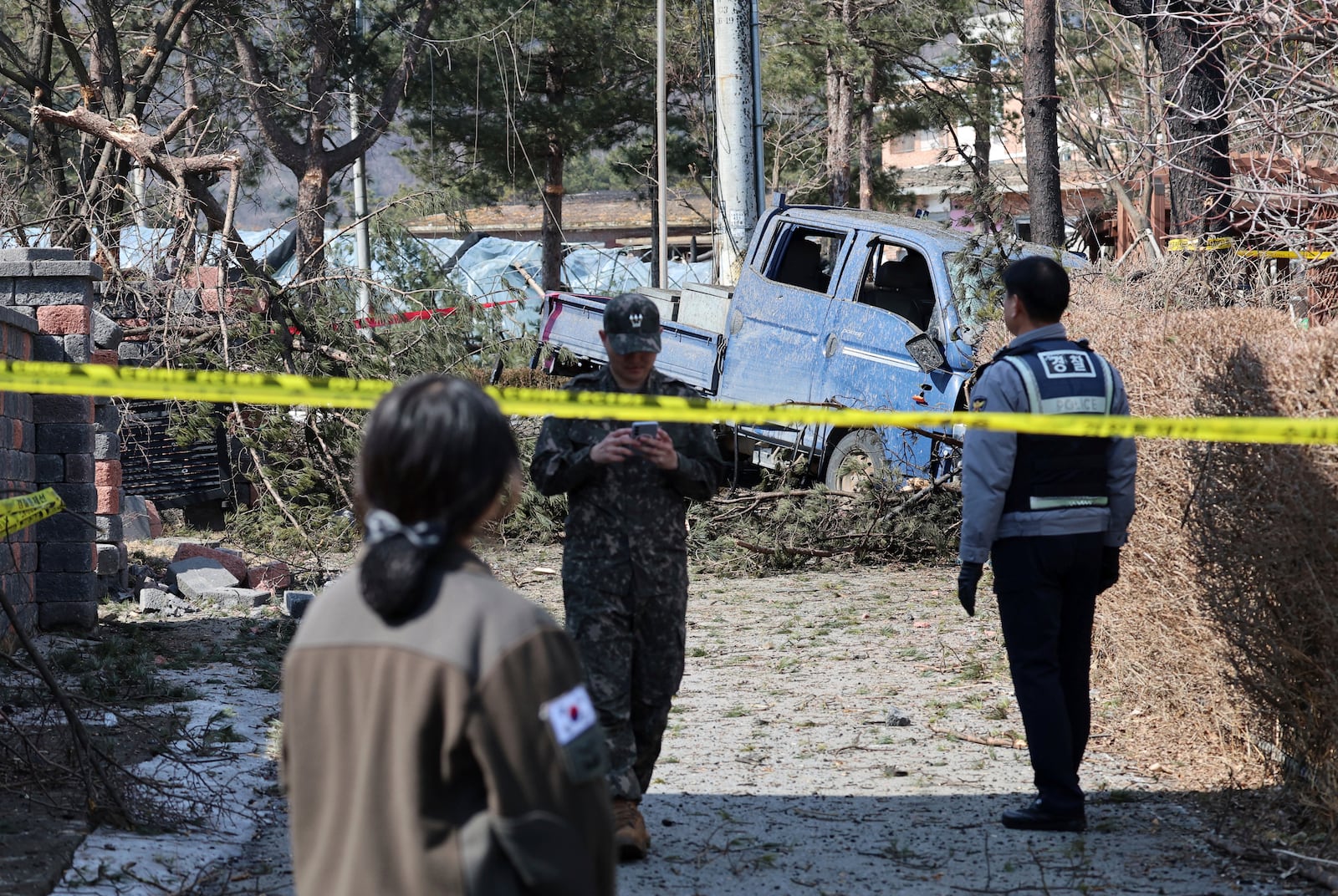 South Korea army soldier police officer stand guard near a bomb accident site where a South Korean fighter jet accidentally dropped bombs on a civilian area during training, in Pocheon, South Korea, Thursday, March 6, 2025. (Yonhap via AP)