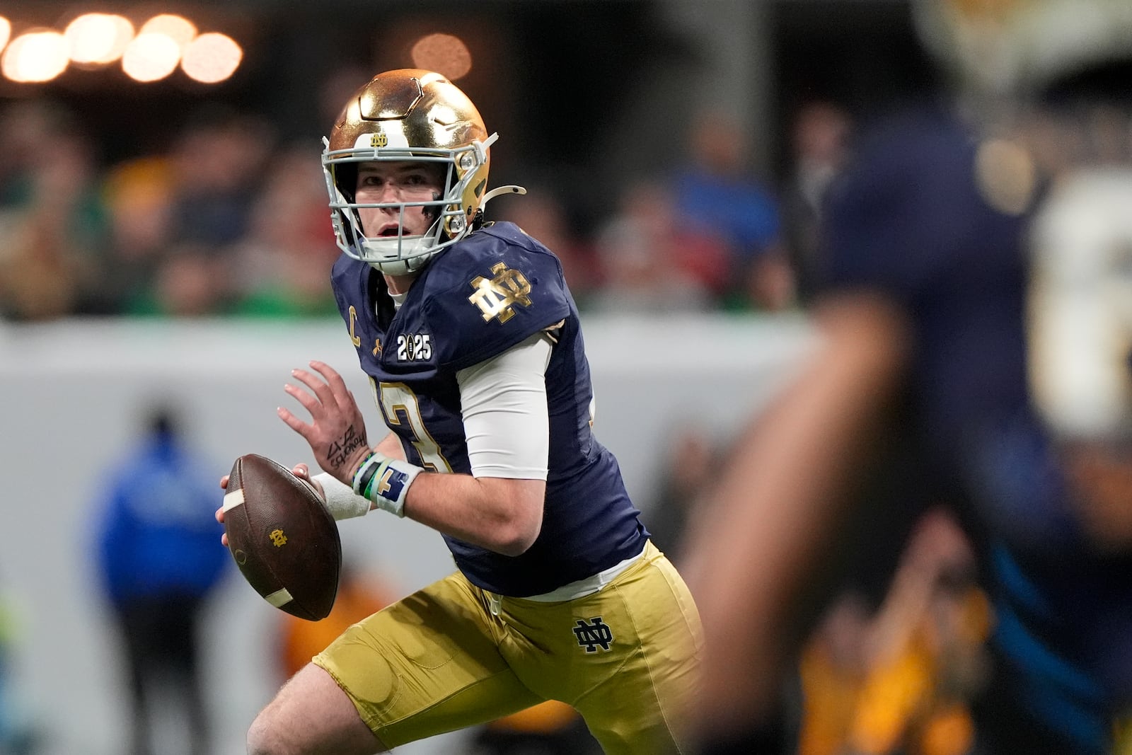 Notre Dame quarterback Riley Leonard runs against Ohio State during first half of the College Football Playoff national championship game Monday, Jan. 20, 2025, in Atlanta. (AP Photo/Brynn Anderson)