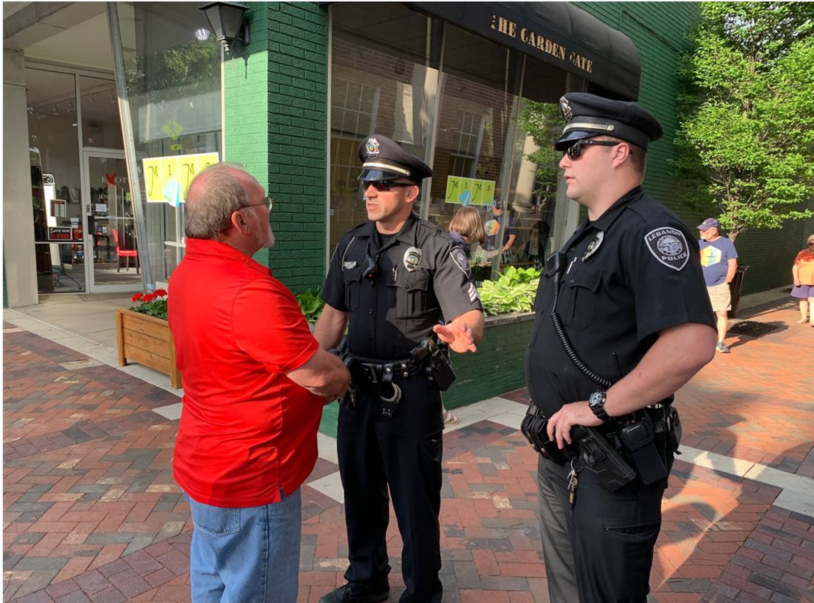 Lebanon police talk to resident Mark Bledsoe after he was separated for trying to  shout down pro-abortion supporters during a rally Tuesday night in front of the Lebanon City Building. The pro-abortion organizers had a city-issued permit to hold the rally before the Lebanon City Council meeting. ED RICHTER/STAFF