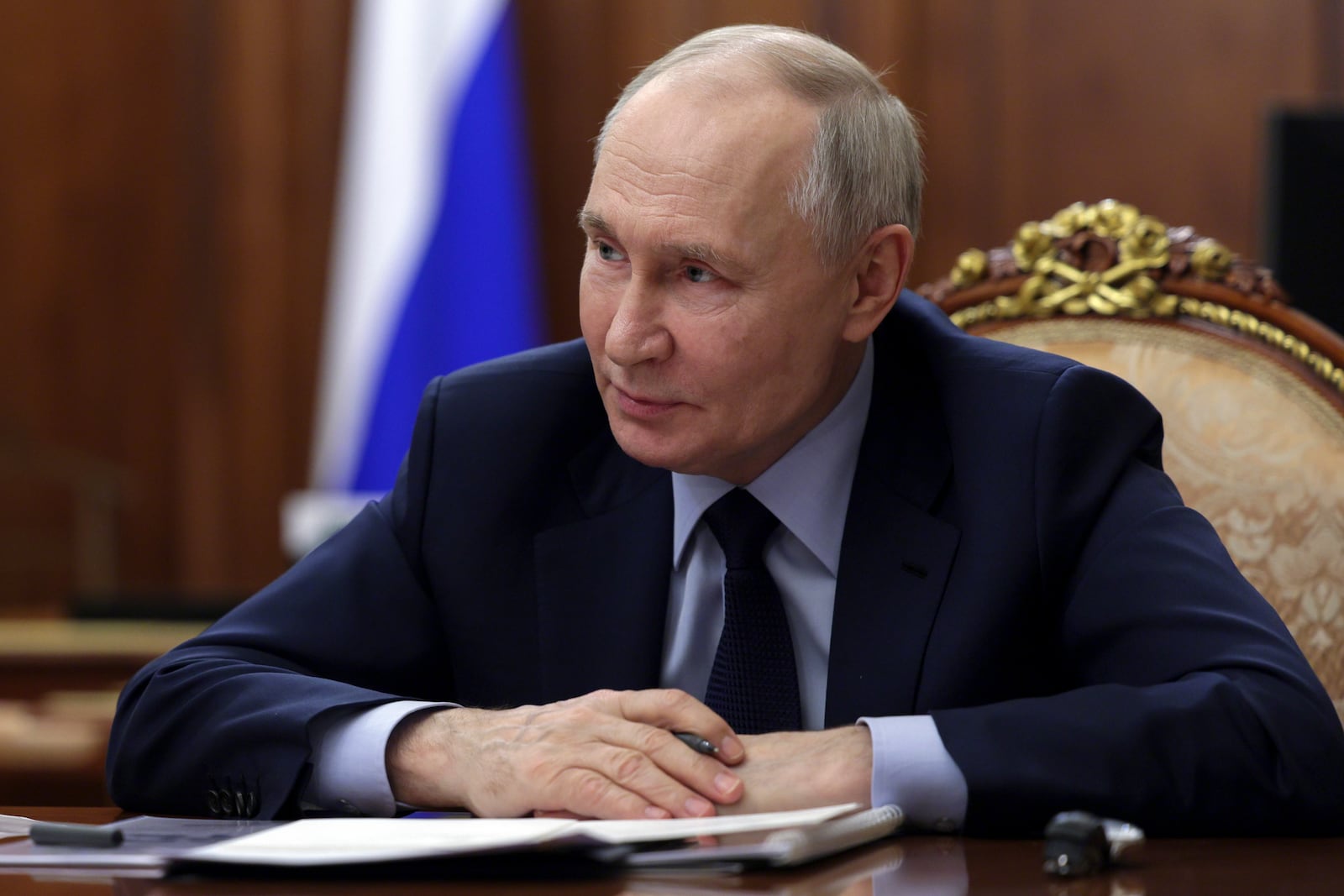 Russian President Vladimir Putin listens to acting Governor of the Kursk Region Alexander Khinshtein during their meeting at the Kremlin in Moscow, Russia, Wednesday, Feb. 5, 2025. (Gavriil Grigorov, Sputnik, Kremlin Pool Photo via AP)